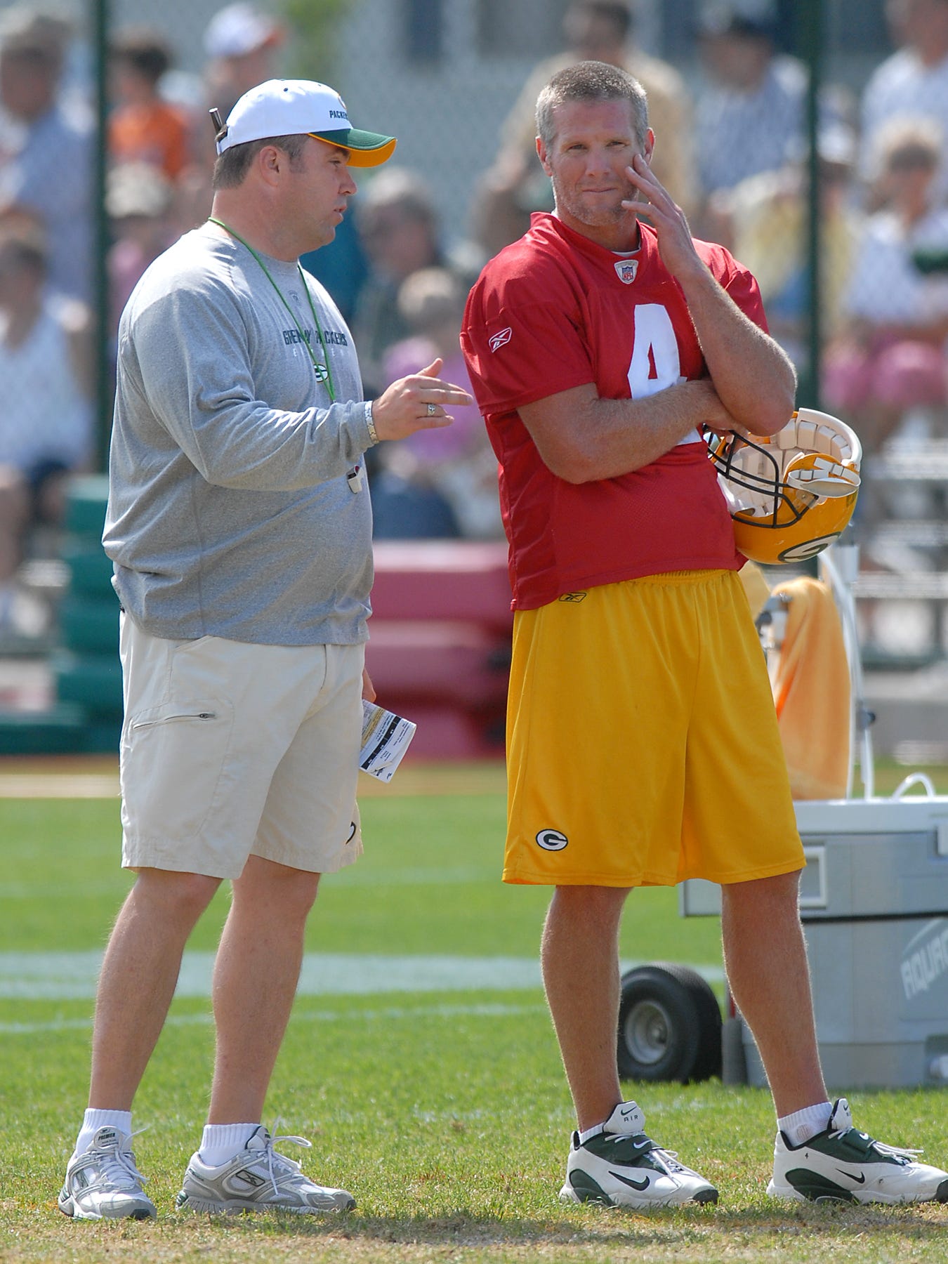 Green Bay Packers coach Mike McCarthy talks with Brett Favre during training camp practice on Aug. 14, 2006.