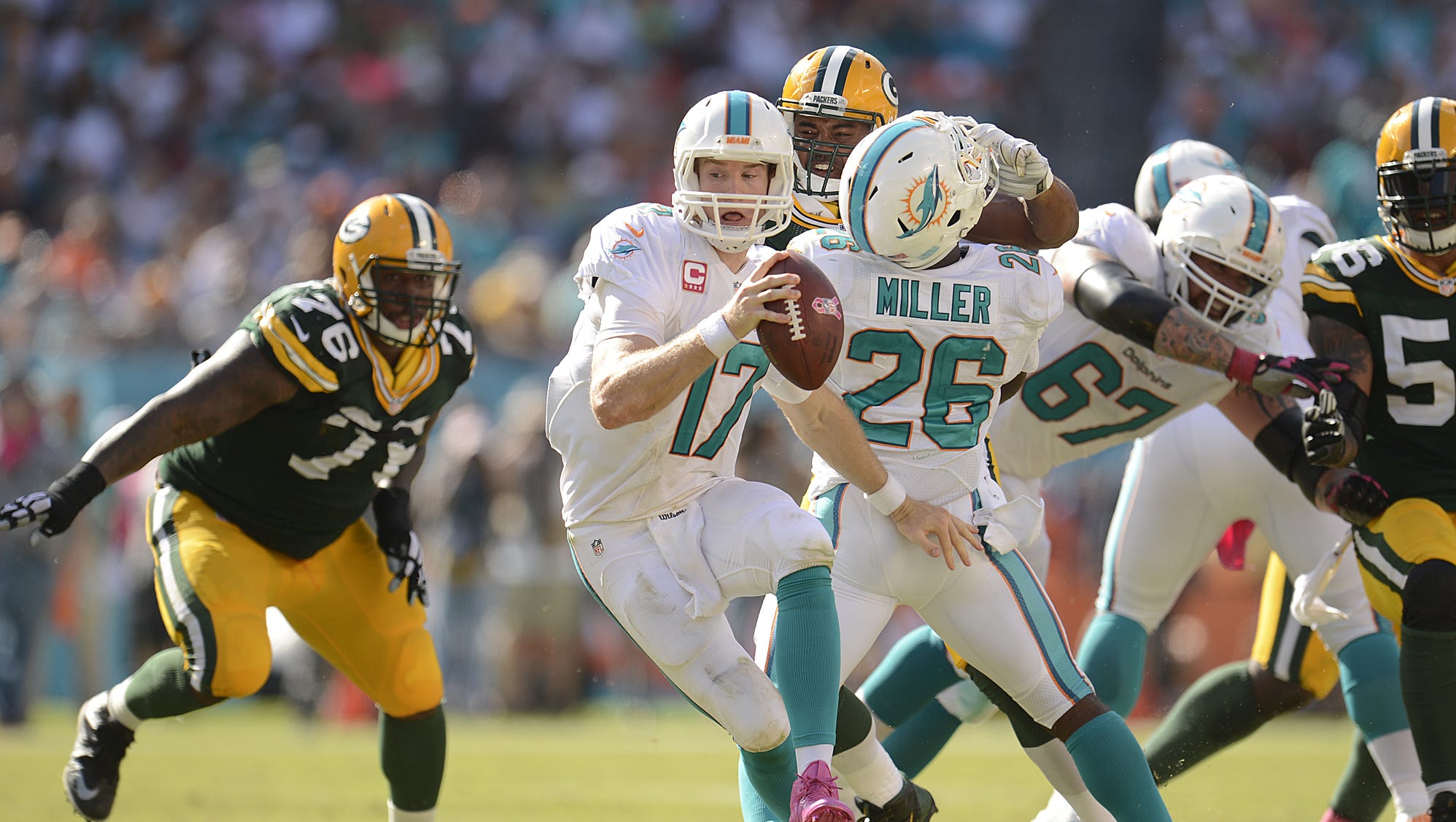 Miami Dolphins quarterback Ryan Tannehill (17) feels the pressure from the Packers defense on Oct. 11, 2014, at Sun Life Stadium in Miami.