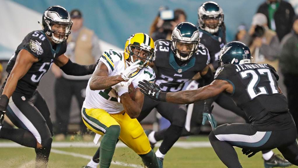 Green Bay Packers wide receiver Davante Adams (17) gets surrounded by defenders after a catch against the Philadelphia Eagles at Lincoln Financial Field.