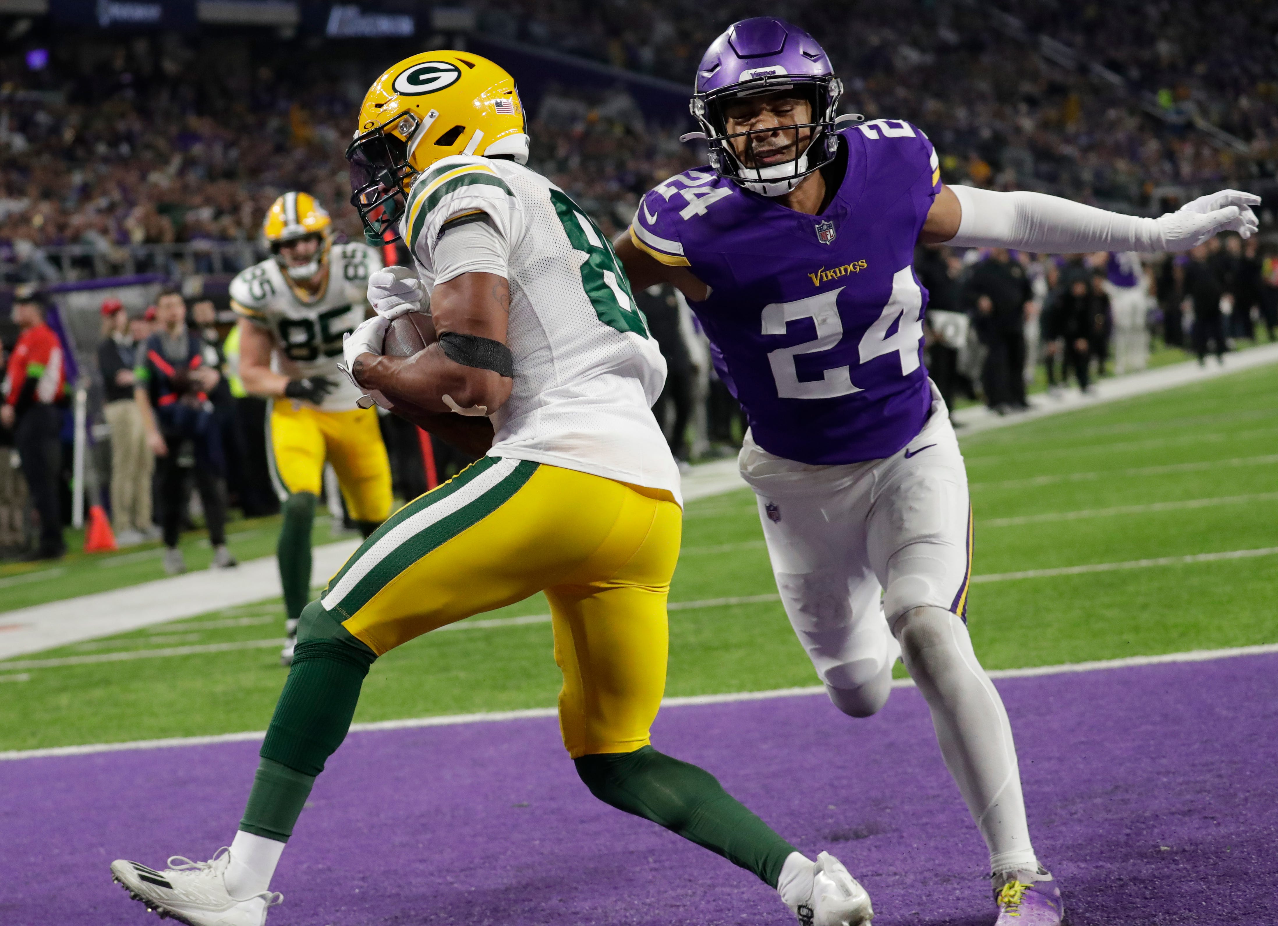 Green Bay Packers wide receiver Bo Melton (80) scores a touchdown reception against Minnesota Vikings safety Camryn Bynum (24) during their football game Sunday, December 31, 2023, at U.S. Bank Stadium in Minneapolis, Minnesota.