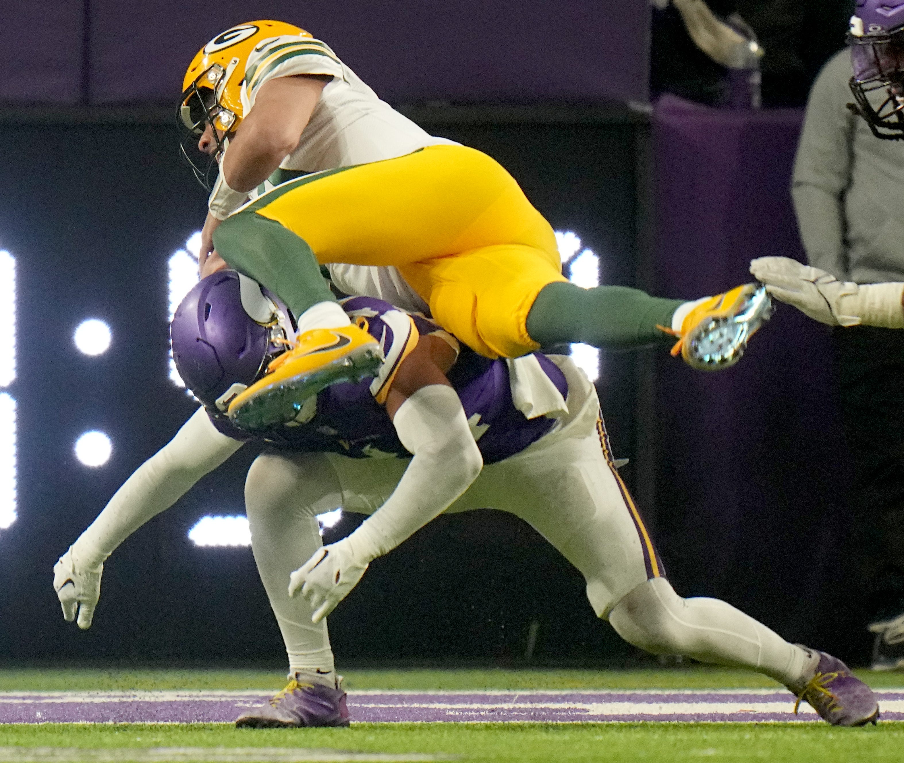 Green Bay Packers quarterback Jordan Love (10) scores a touchdown on a three-yard run during the second quarter of their game against the Minnesota Vikings Sunday, Dec. 31, 2023 at U.S. Bank Stadium in Minneapolis, Minnesota.