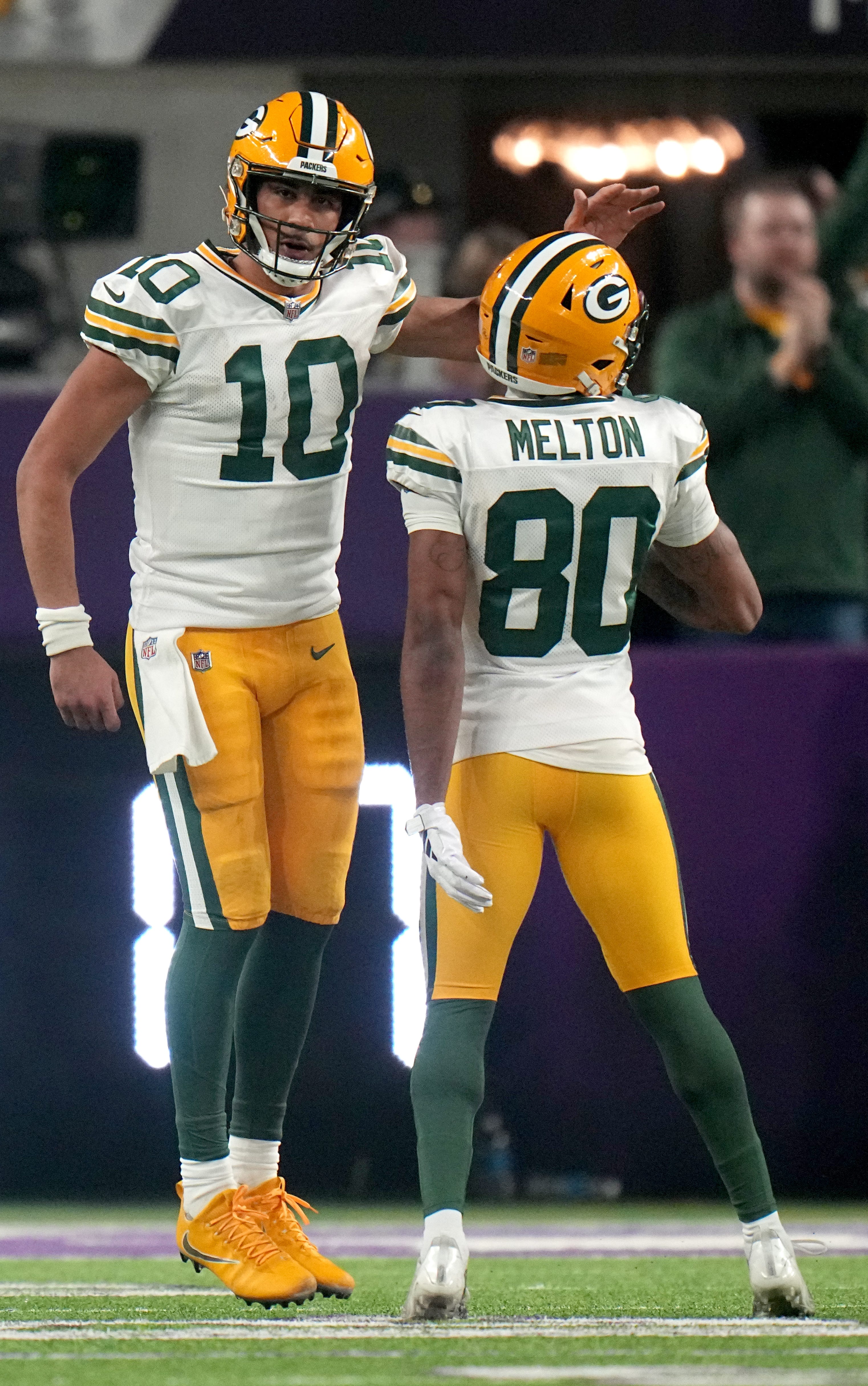 Green Bay Packers quarterback Jordan Love (10) celebrates his touchdown run with wide receiver Bo Melton (80) during the second quarter of their game against the Minnesota Vikings Sunday, Dec. 31, 2023 at U.S. Bank Stadium in Minneapolis, Minnesota.