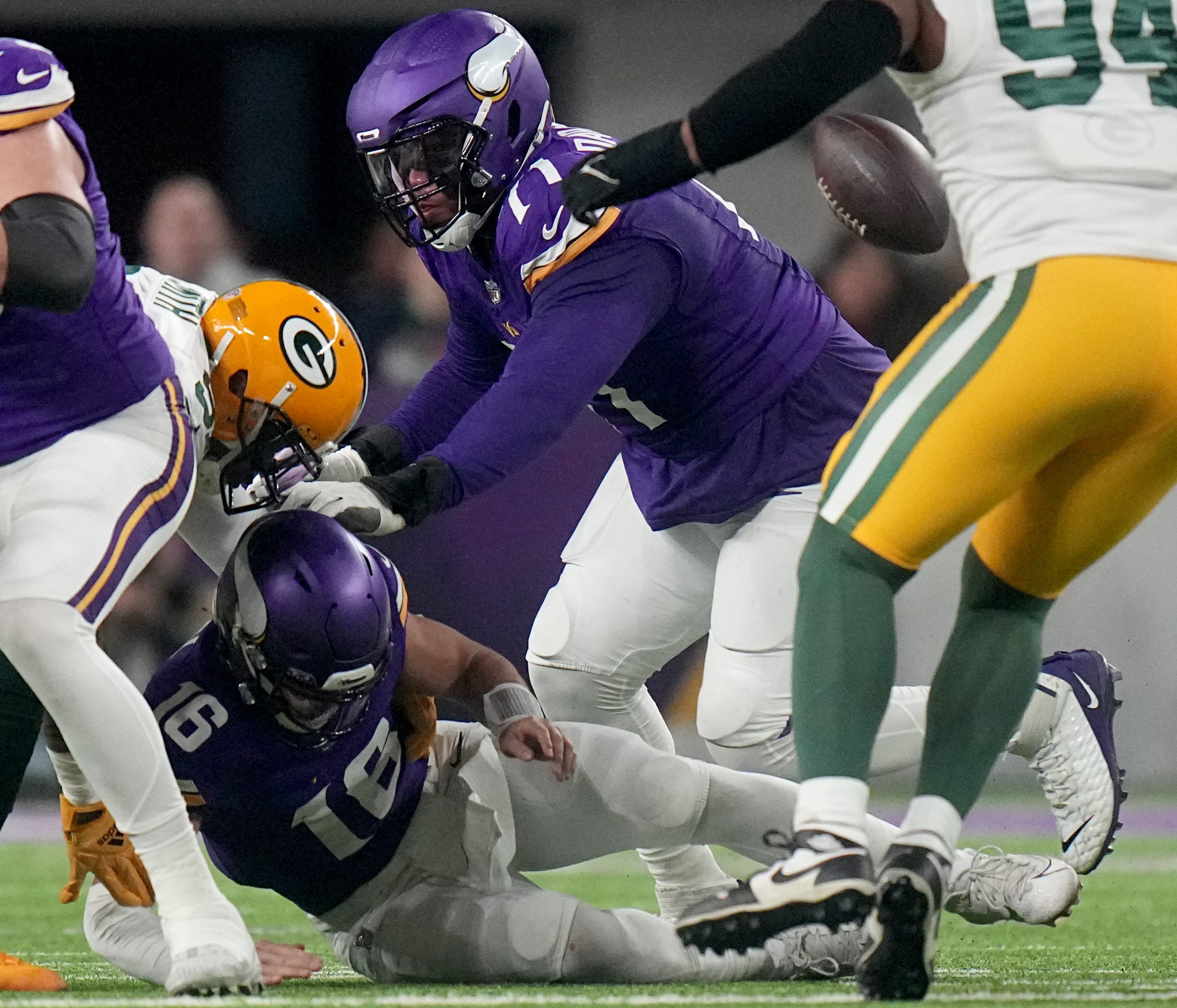 Minnesota Vikings quarterback Jaren Hall (16) fumbles the ball during the second quarter of their game against the Green Bay Packers Sunday, Dec. 31, 2023, at U.S. Bank Stadium in Minneapolis, Minnesota. The Packers recovered the ball.