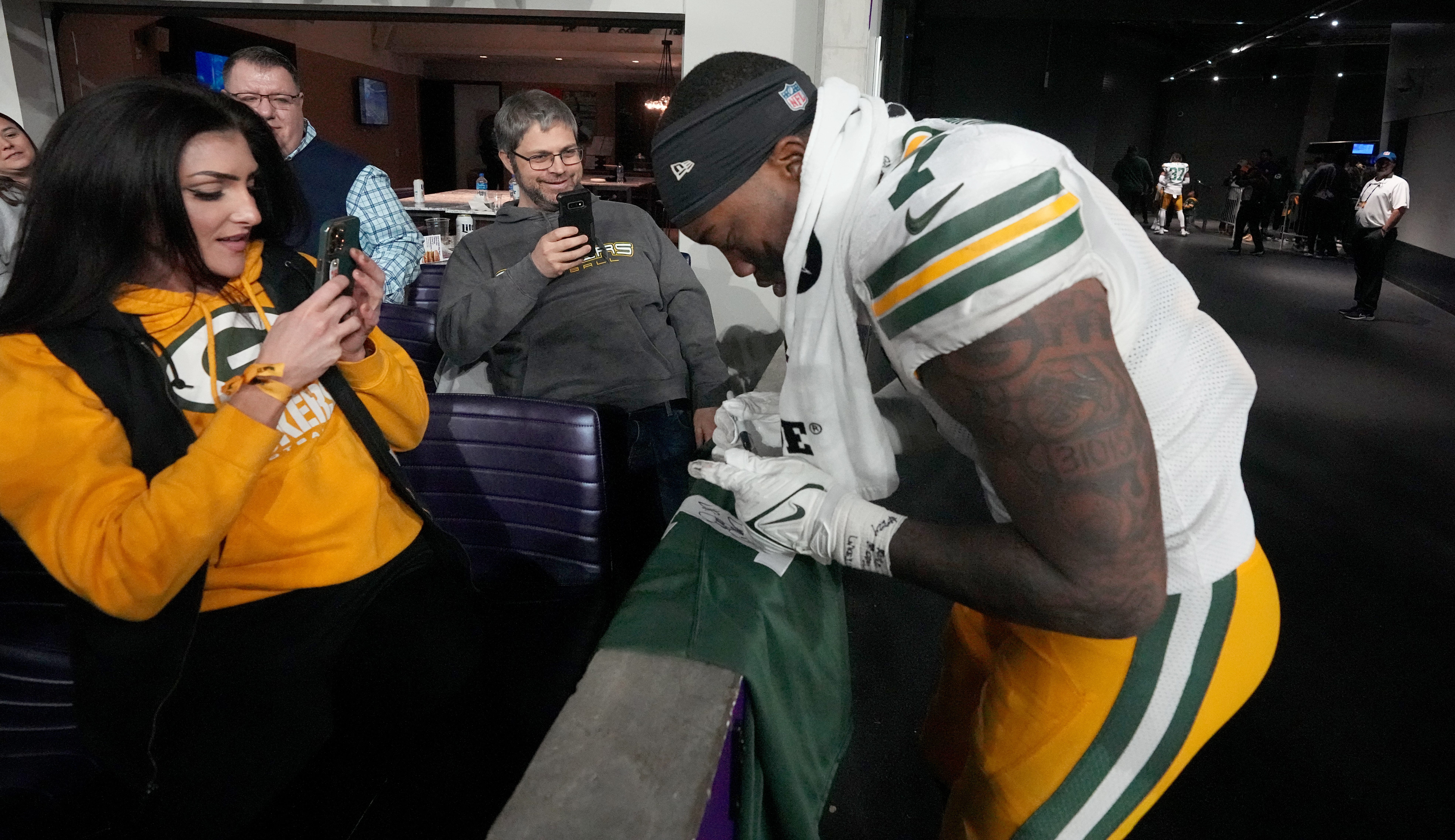 Green Bay Packers linebacker Quay Walker (7) signs a jersey after their game Sunday, December 31, 2023 at U.S. Bank Stadium in Minneapolis, Minnesota. The Green Bay Packers beat the Minnesota Vikings 33-10.