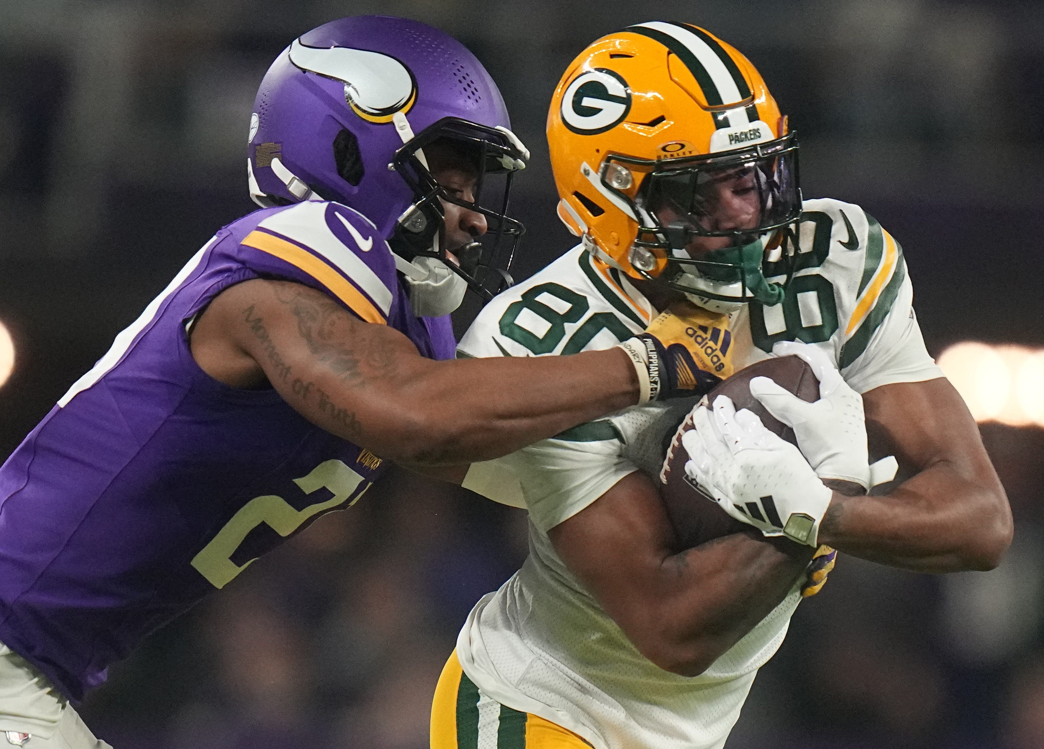 Green Bay Packers wide receiver Bo Melton (80) makes a 12-yard reception before being tackled by Minnesota Vikings cornerback Akayleb Evans (21) during the first quarter of their game Sunday, December 31, 2023 at U.S. Bank Stadium in Minneapolis, Minnesota.