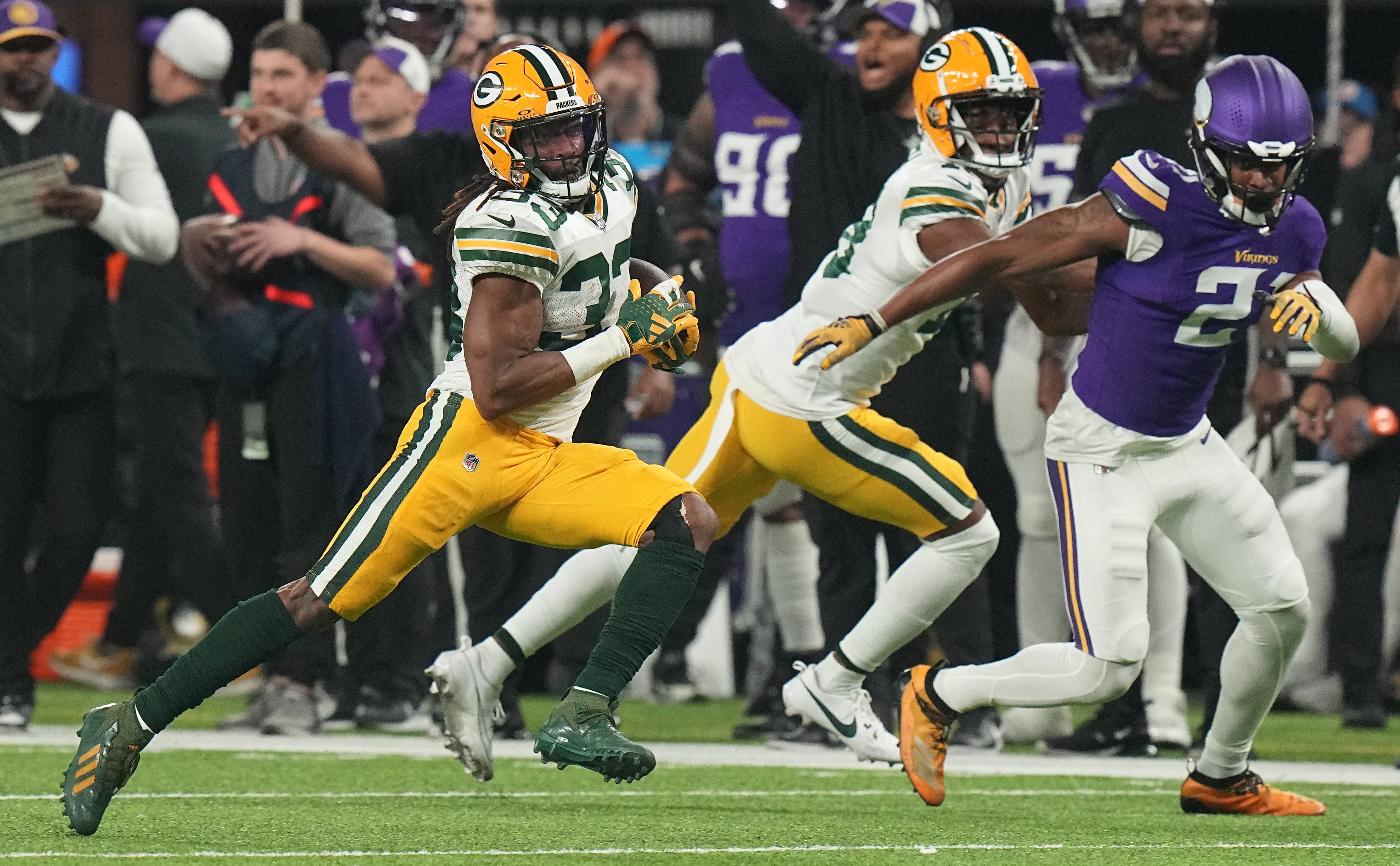 Green Bay Packers running back Aaron Jones (33) picks up 19y and on a run during the first quarter of their game Sunday, December 31, 2023 at U.S. Bank Stadium in Minneapolis, Minnesota. The Green Bay Packers beat the Minnesota Vikings 33-10.