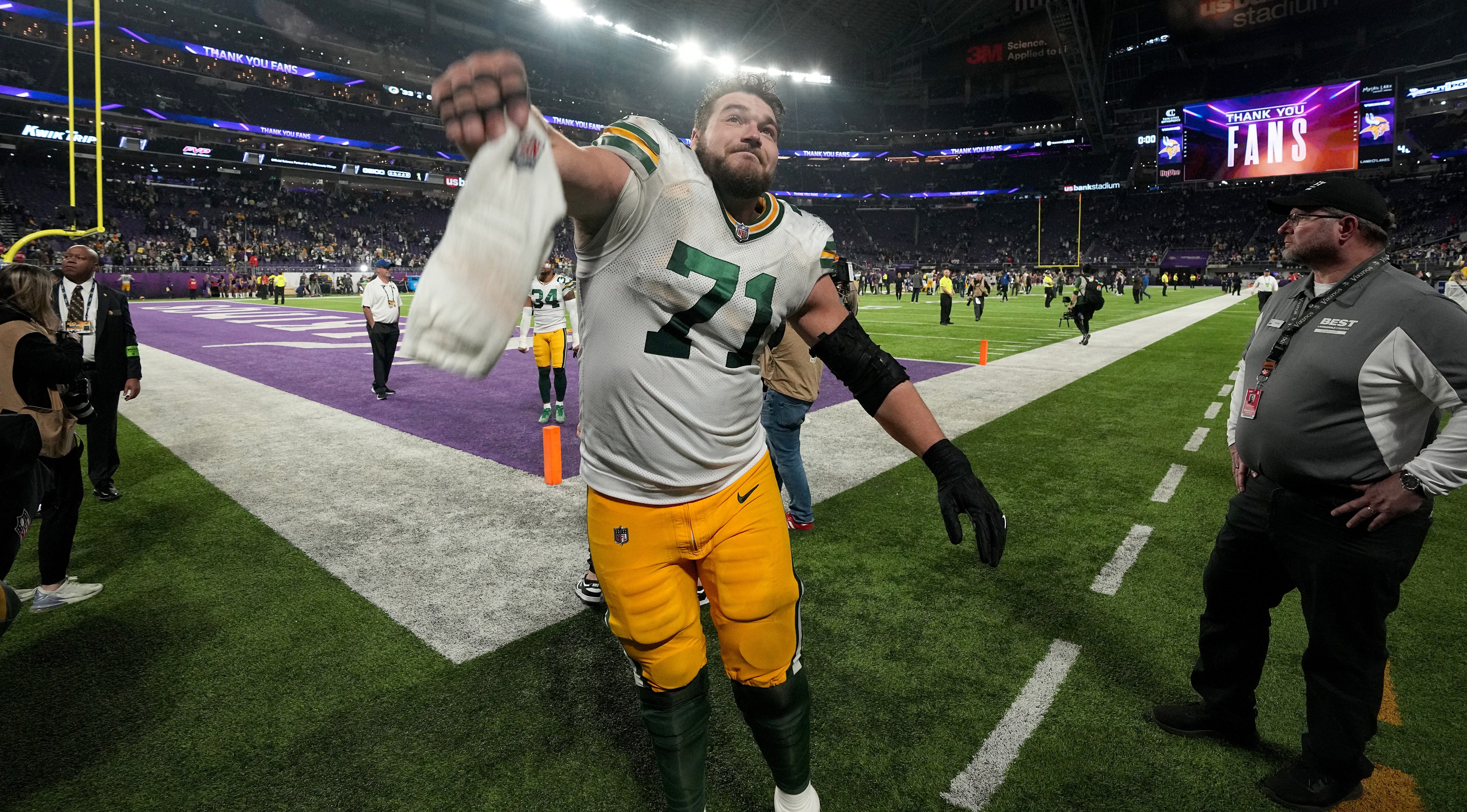 Green Bay Packers center Josh Myers (71) throws a towel into the stands while celebrating his team’s win after their game Sunday, December 31, 2023 at U.S. Bank Stadium in Minneapolis, Minnesota. The Green Bay Packers beat the Minnesota Vikings 33-10.