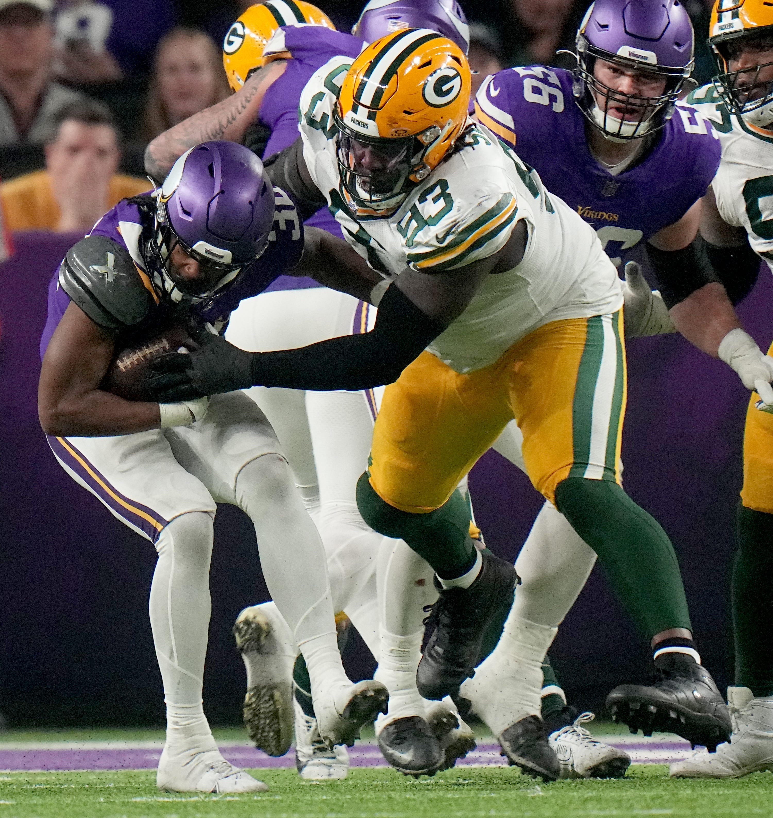 Green Bay Packers defensive lineman T.J. Slaton stuff Minnesota Vikings running back Ty Chanlr at the line during the fourth quarter of their game Sunday, December 31, 2023 at U.S. Bank Stadium in Minneapolis, Minnesota. The Green Bay Packers beat the Minnesota Vikings 33-10.