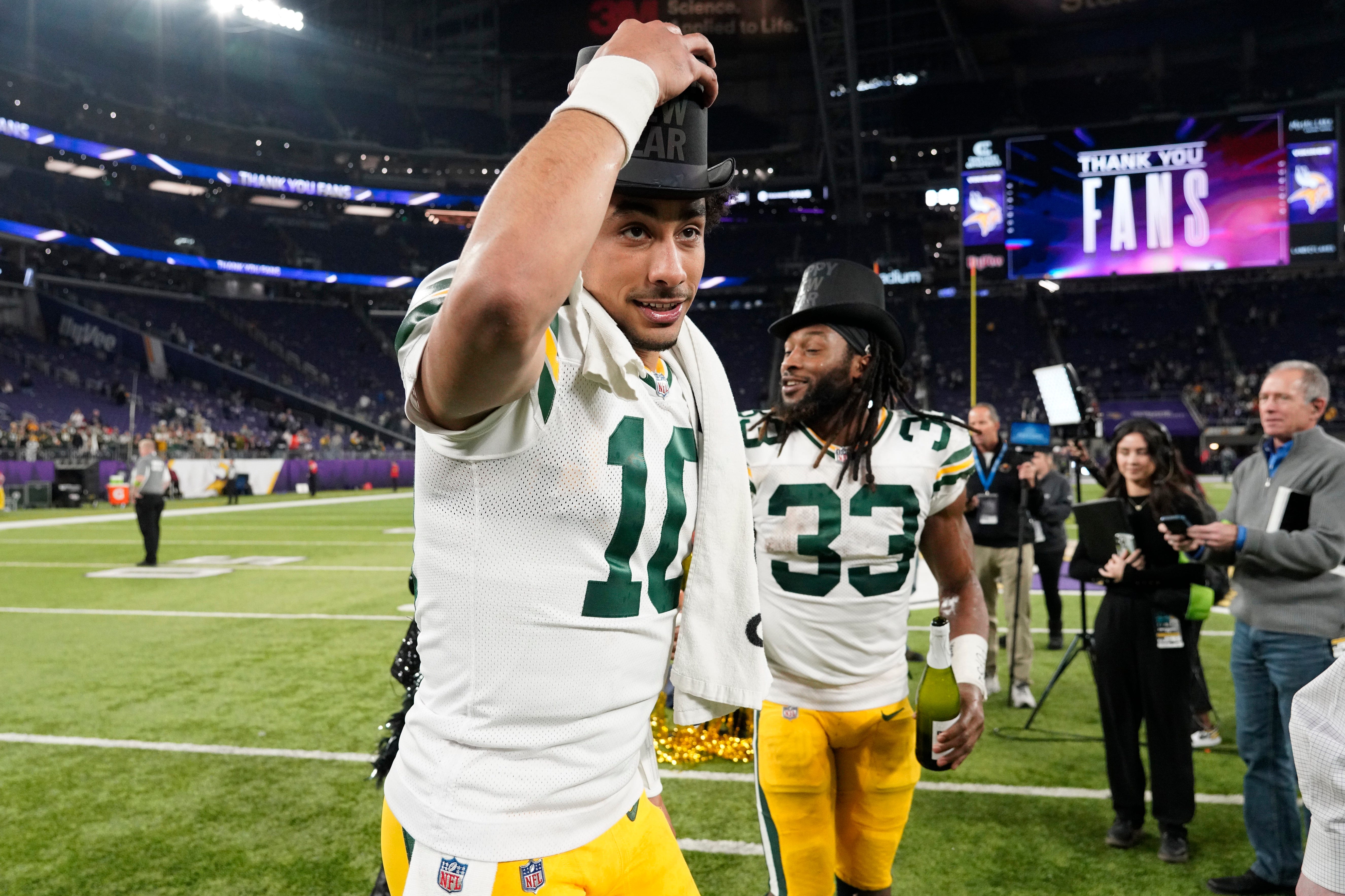 MINNEAPOLIS, MINNESOTA - DECEMBER 31: Jordan Love #10 and Aaron Jones #33 of the Green Bay Packers celebrate after a 33-10 victory against the Minnesota Vikings at U.S. Bank Stadium on December 31, 2023 in Minneapolis, Minnesota. (Photo by David Berding/Getty Images)