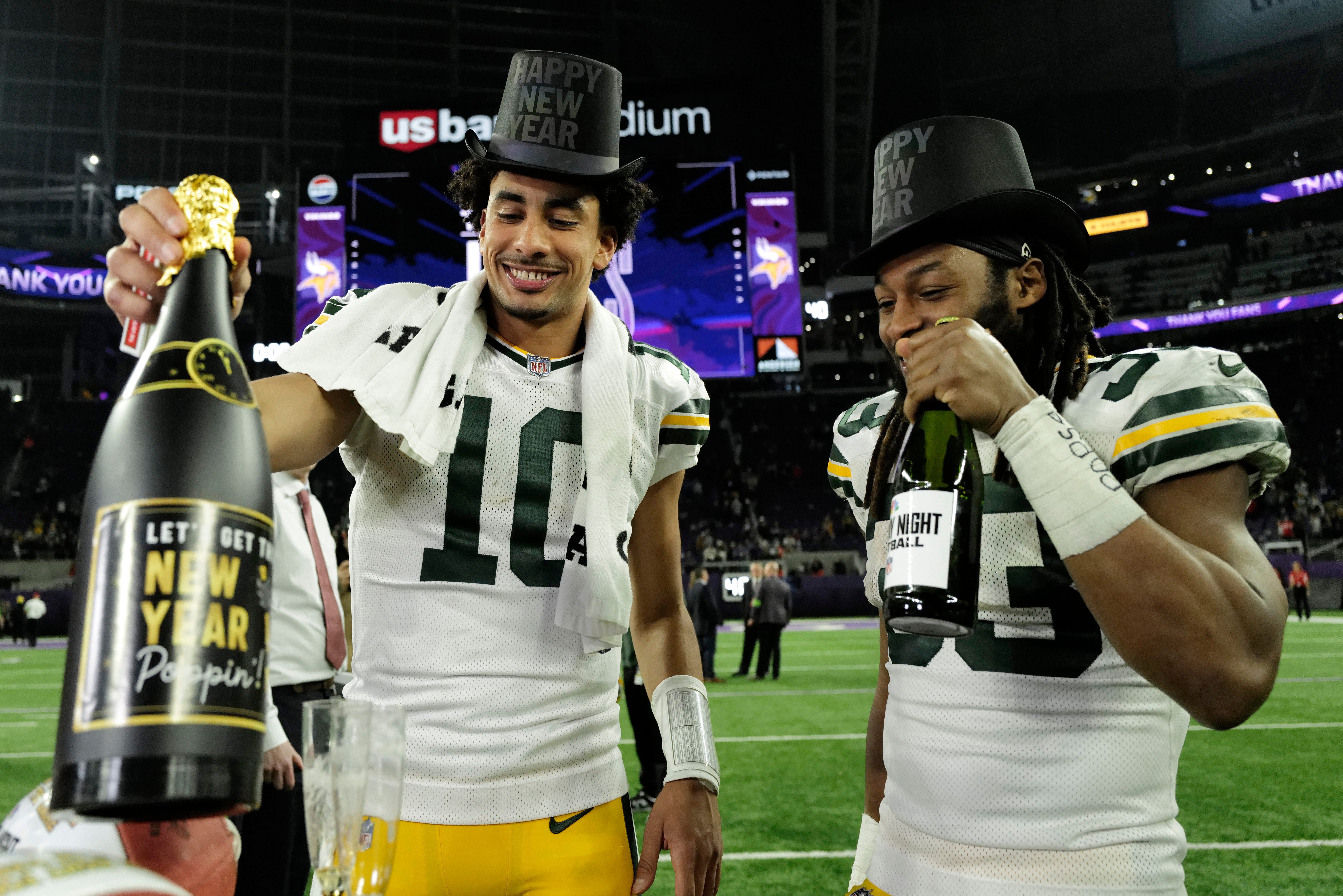 MINNEAPOLIS, MINNESOTA - DECEMBER 31: Jordan Love #10 and Aaron Jones #33 of the Green Bay Packers celebrate after a 33-10 victory against the Minnesota Vikings at U.S. Bank Stadium on December 31, 2023 in Minneapolis, Minnesota. (Photo by Stephen Maturen/Getty Images)