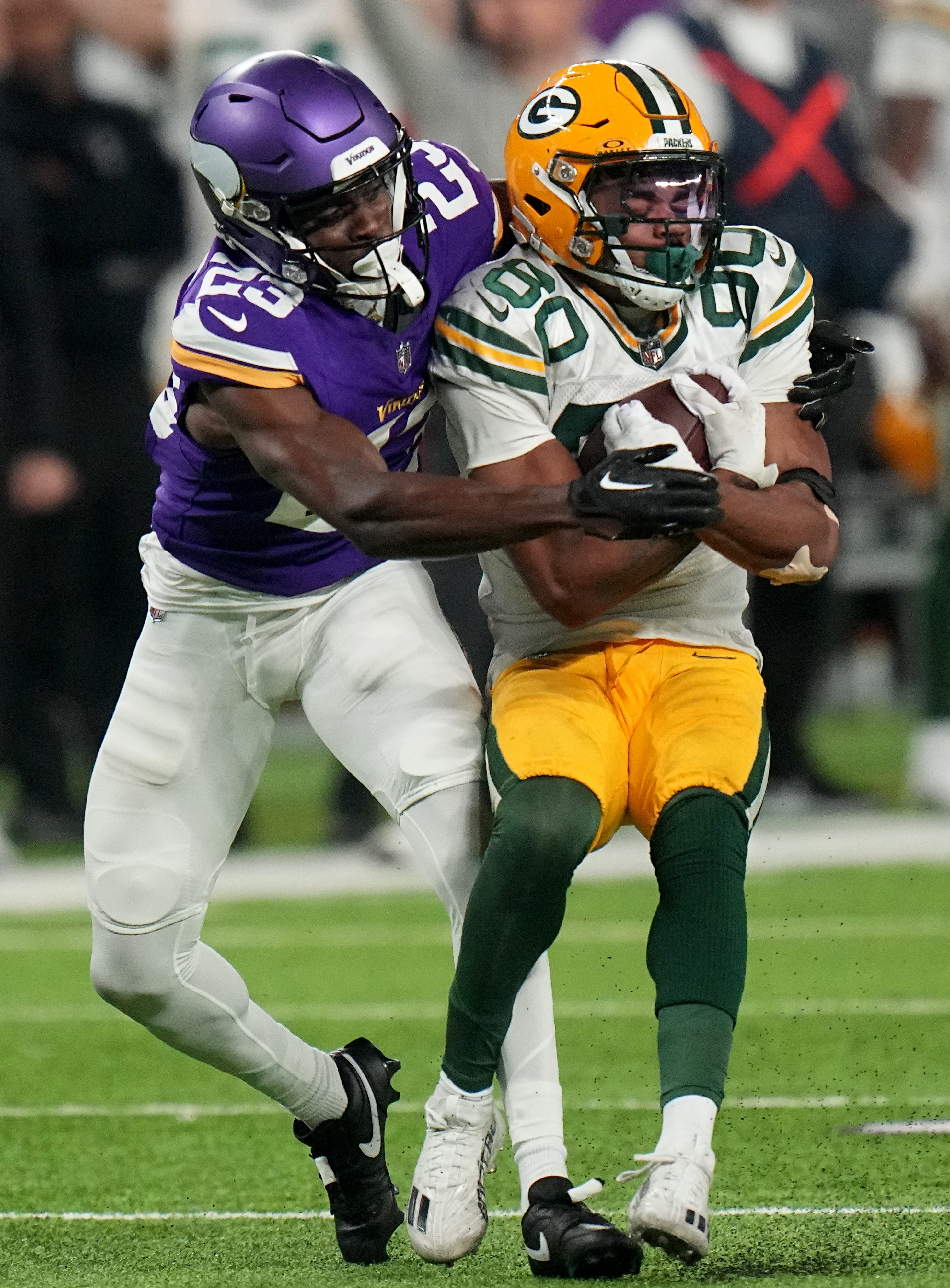 Green Bay Packers wide receiver Bo Melton (80) catches a 37-yard before being tackled by Minnesota Vikings cornerback Andrew Booth Jr. (23) during the fourth quarter of their game Sunday, December 31, 2023 at U.S. Bank Stadium in Minneapolis, Minnesota. The Green Bay Packers beat the Minnesota Vikings 33-10.
