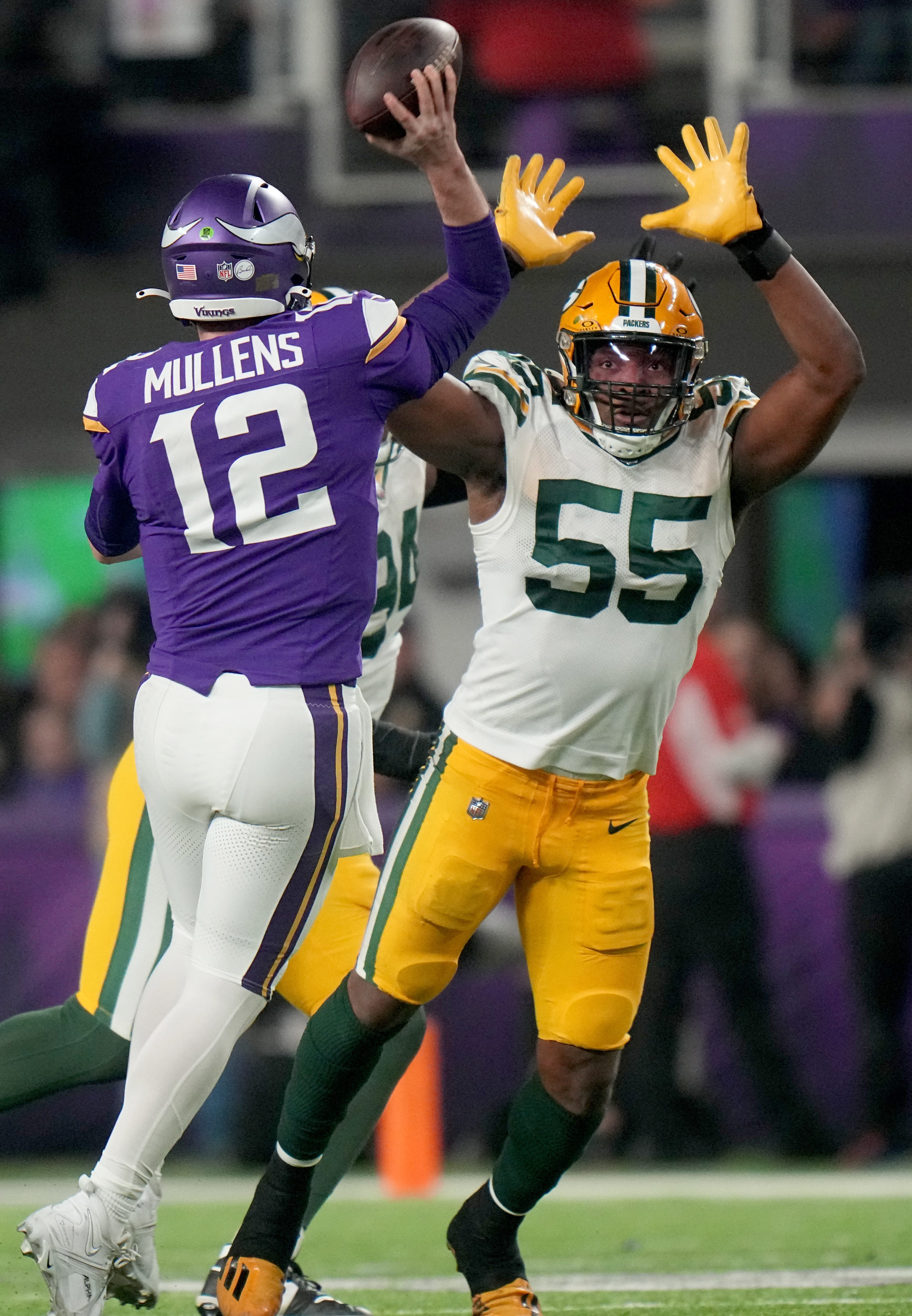 Minnesota Vikings quarterback Nick Mullens (12) is pressed by Green Bay Packers linebacker Kingsley Enagbare (55) during the fourth quarter of their game Sunday, December 31, 2023 at U.S. Bank Stadium in Minneapolis, Minnesota. The Green Bay Packers beat the Minnesota Vikings 33-10.