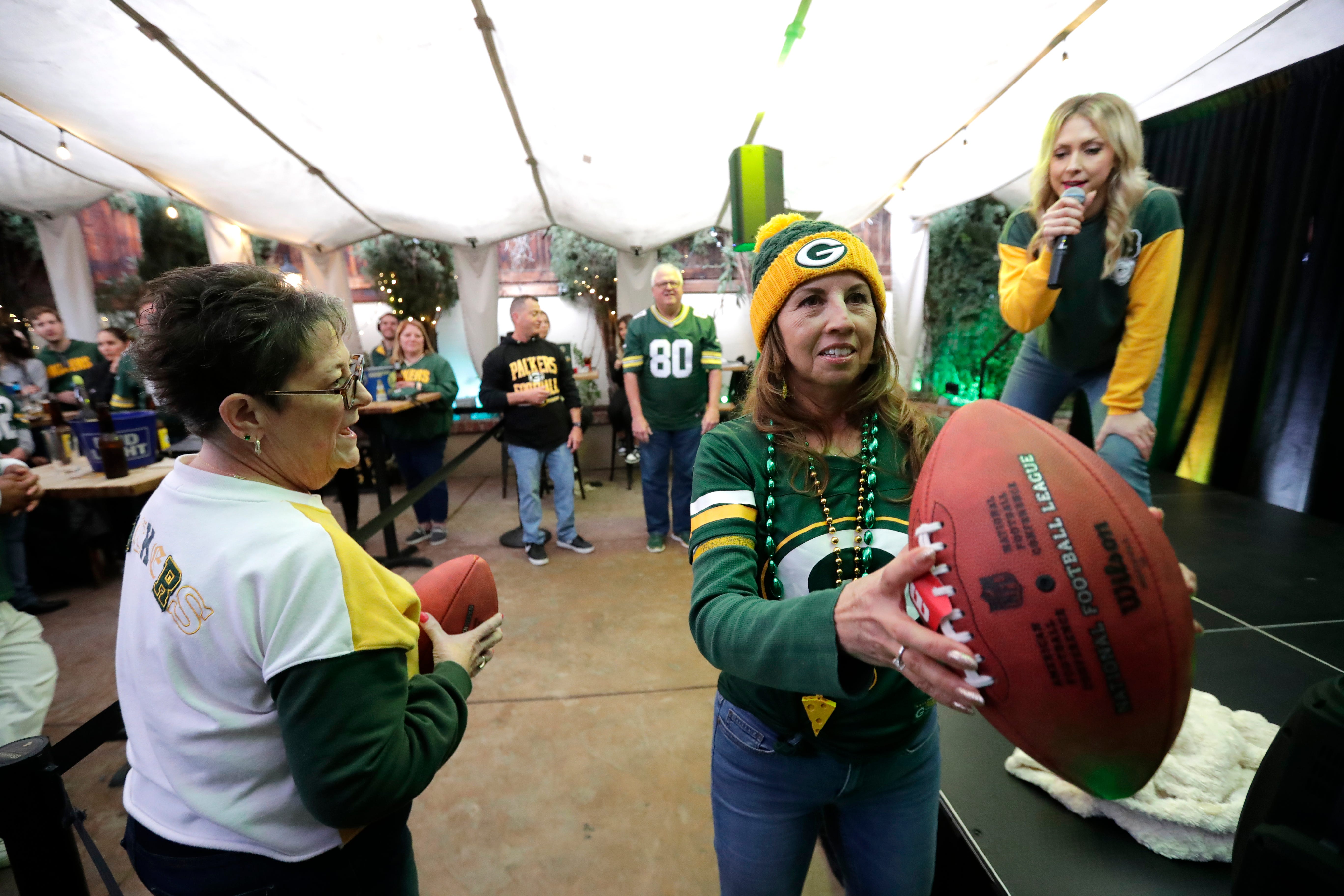 Green Bay Packers fans participate in a game to win prizes during the Packers Everywhere pep rally Friday, January 19, 2024, at The Patio in Palo Alto, California.