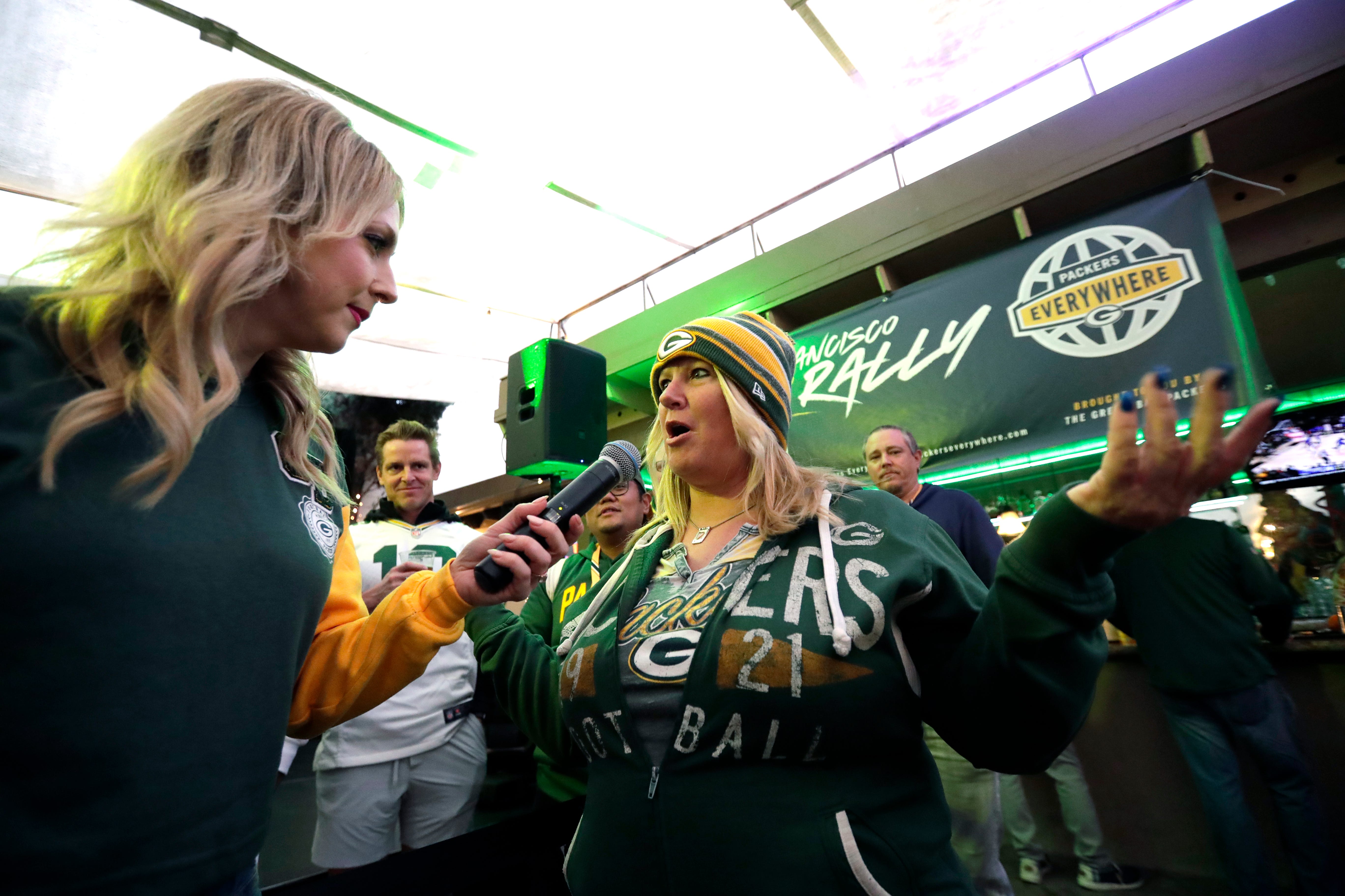 Packers Everywhere host Rebecca Zaccard, left, taks with Shelly Seebeck of Las Vegas, Nevada, during the Packers Everywhere pep rally Friday, January 19, 2024, at The Patio in Palo Alto, California.