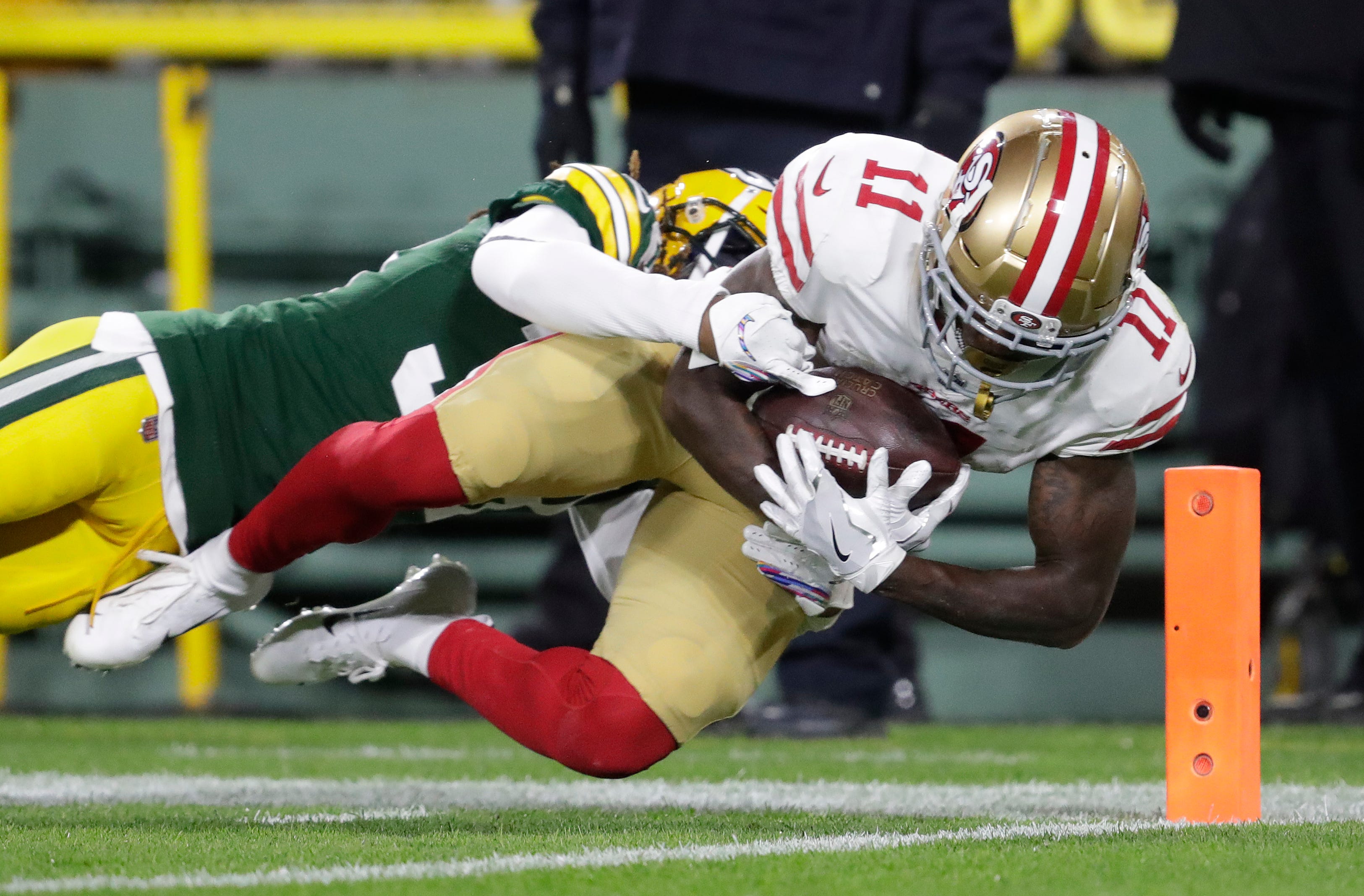San Francisco 49ers wide receiver Marquise Goodwin (11) dives into the end zone for a touchdown against Green Bay Packers cornerback Tramon Williams (38) in the second quarter during their football game Monday, Oct. 15, 2018, at Lambeau Field in Green Bay, Wis. 
Dan Powers/USA TODAY NETWORK-Wisconsin