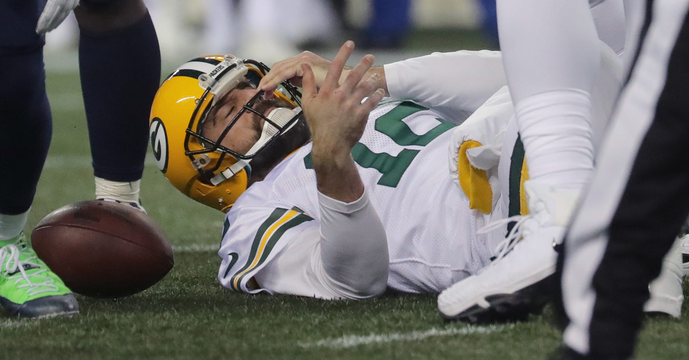 Green Bay Packers quarterback Aaron Rodgers (12) adjust his helmet after being sacked during the second quarter of their game against the Seattle Seahawks Thursday, November 25, 2018 at CenturyLink Field in Seattle, Wash.

MARK HOFFMAN/MHOFFMAN@JOURNALSENTINEL.COM