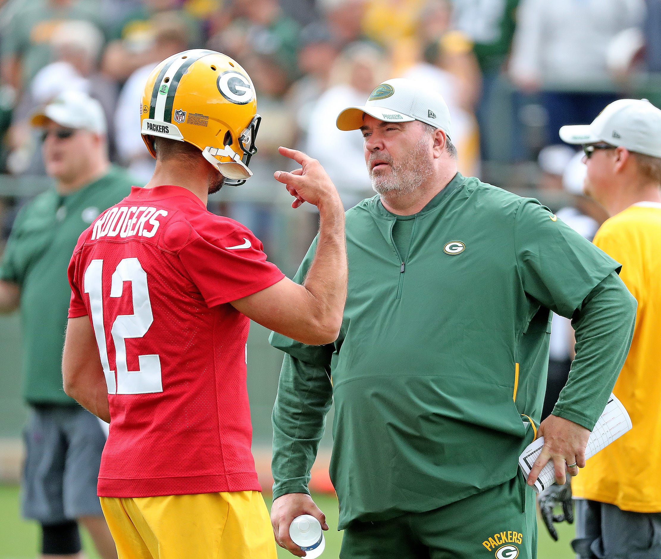 Green Bay Packers quarterback Aaron Rodgers (12) talks with head coach Mike McCarthy during Green Bay Packers Training Camp Friday, July 27, 2018 at Ray Nitschke Field in Ashwaubenon, Wis