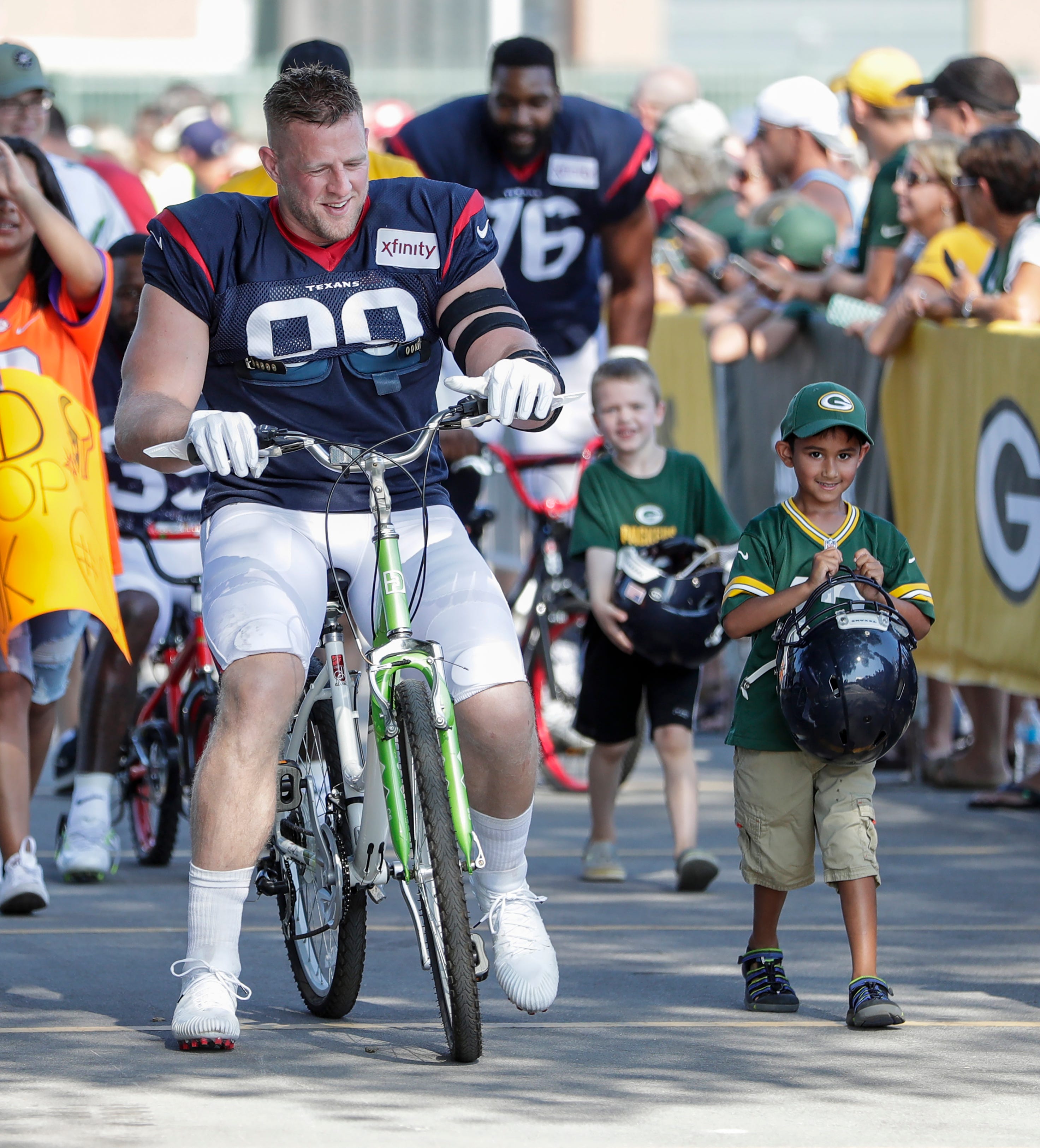 Texans defensive end J. J. Watt rides into to Clarke Hinkle Field for a joint training camp practice with the Green Bay Packers Monday, August 5, 2019, in Ashwaubenon, Wis.