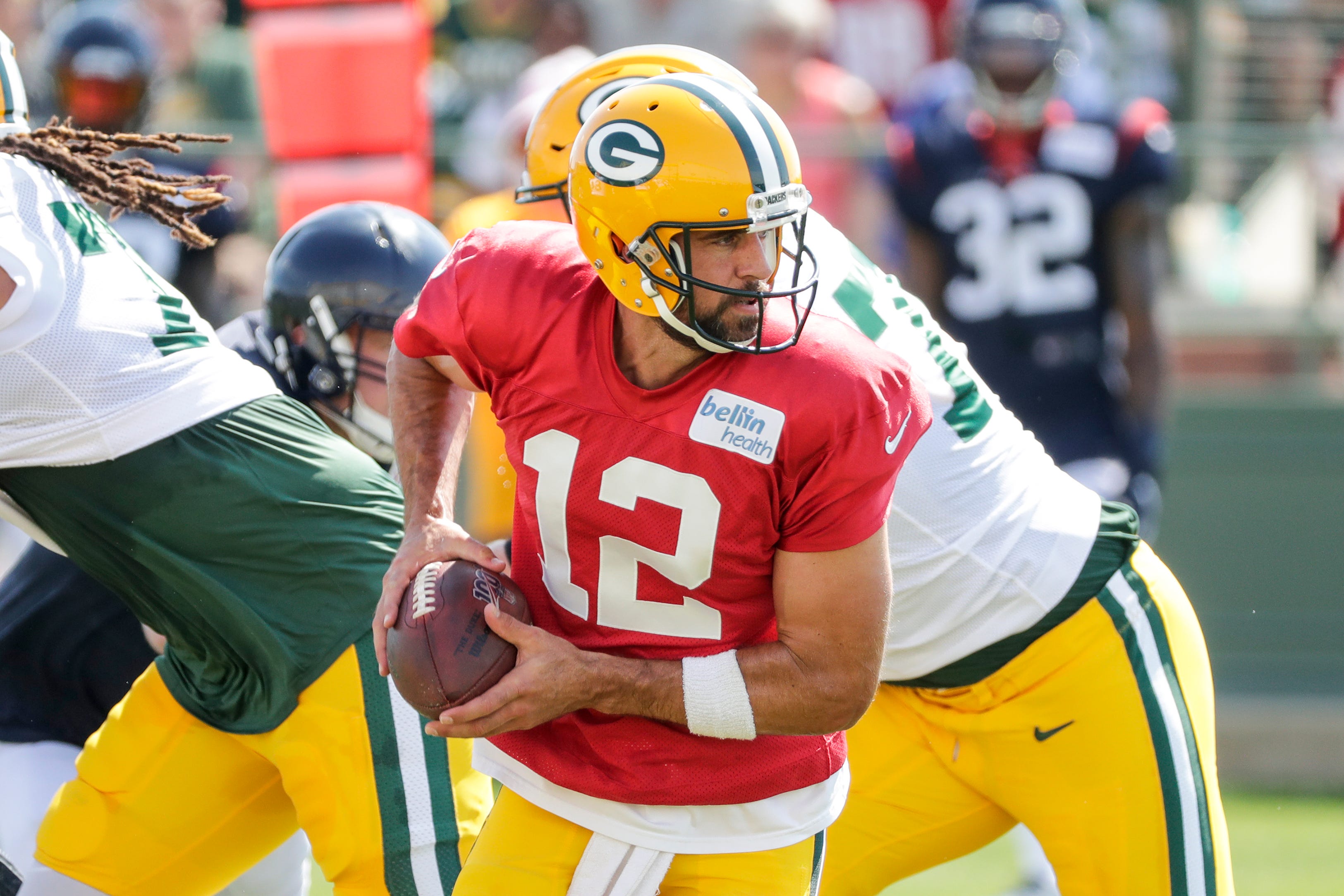 Green Bay quarterback Aaron Rodgers (12) takes a snap during a scrimmage at a joint training camp practice with the Texans at Ray Nitchske Field Monday, August 5, 2019, in Ashwaubenon, Wis.