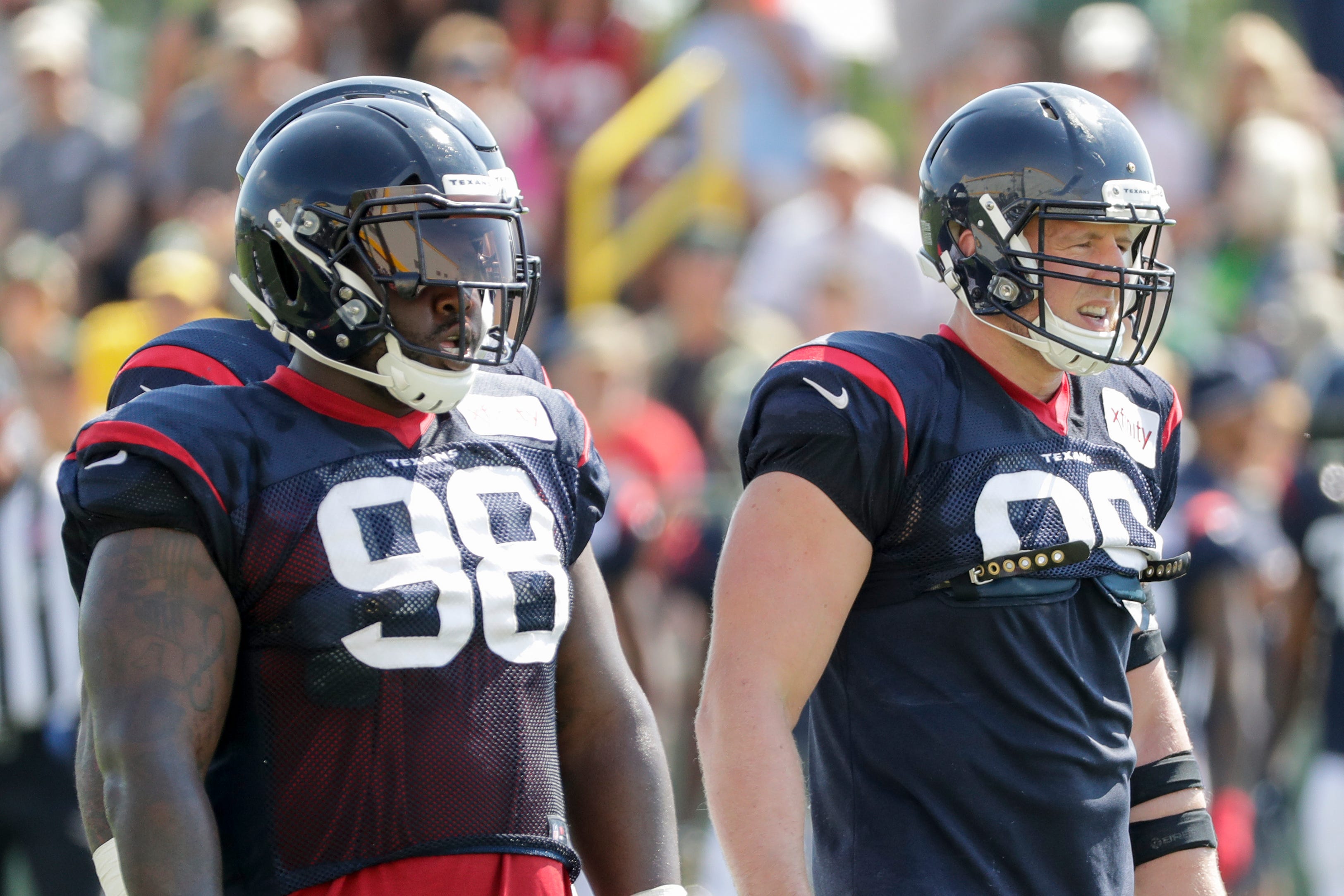 Texans defensive ends D. J. Reader (98) and J. J. Watt (99) line up for a scrimmage during a joint training camp practice with the Green Bay Packers at Ray Nitchske Field Monday, August 5, 2019, in Ashwaubenon, Wis.