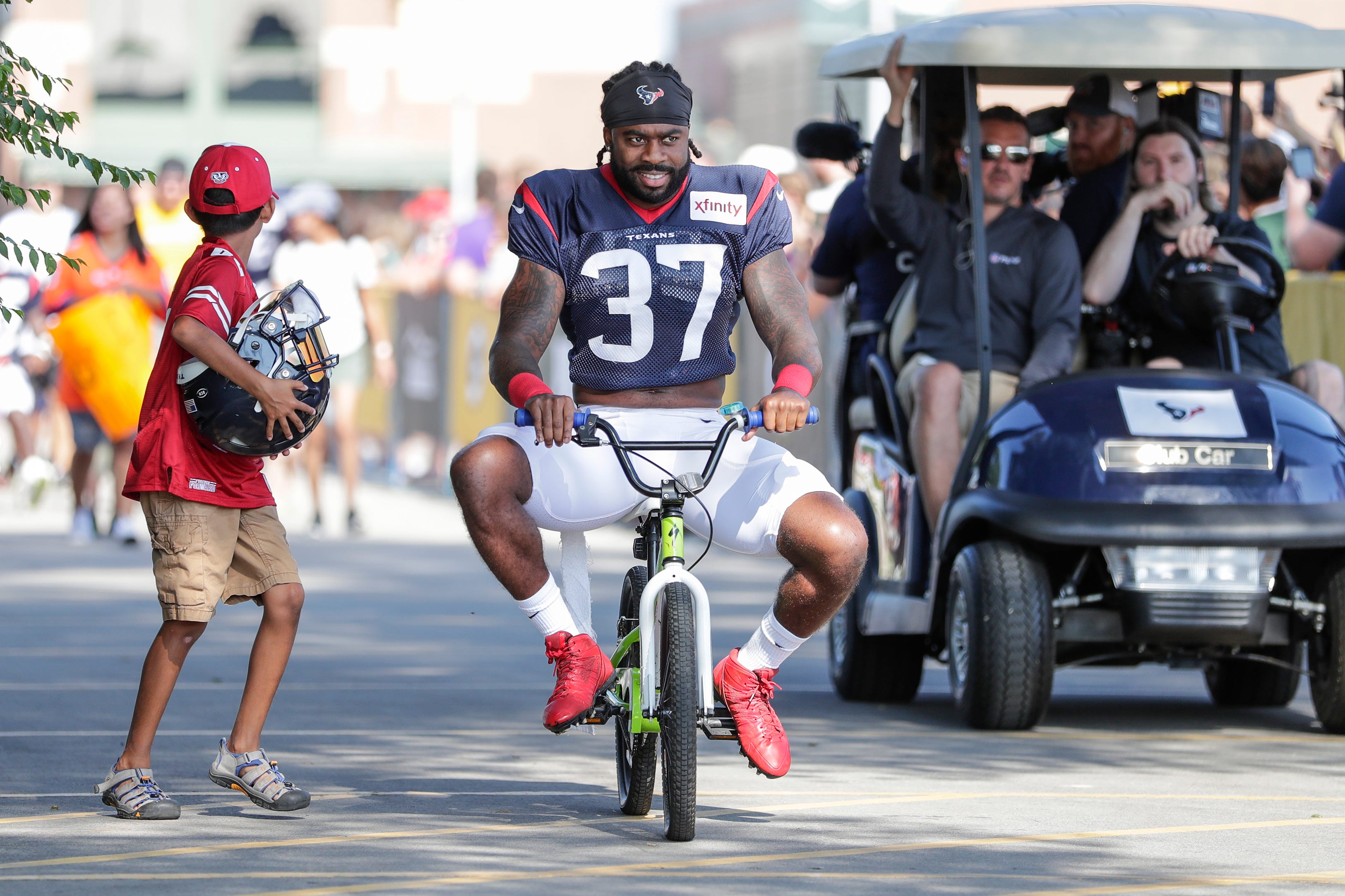 Texans safety Jahleel Addae (37) joins the Packers tradition of riding bikes to Don Hinckle Field for a joint training camp practice with the Green Bay Packers Monday, August 5, 2019, in Ashwaubenon, Wis.