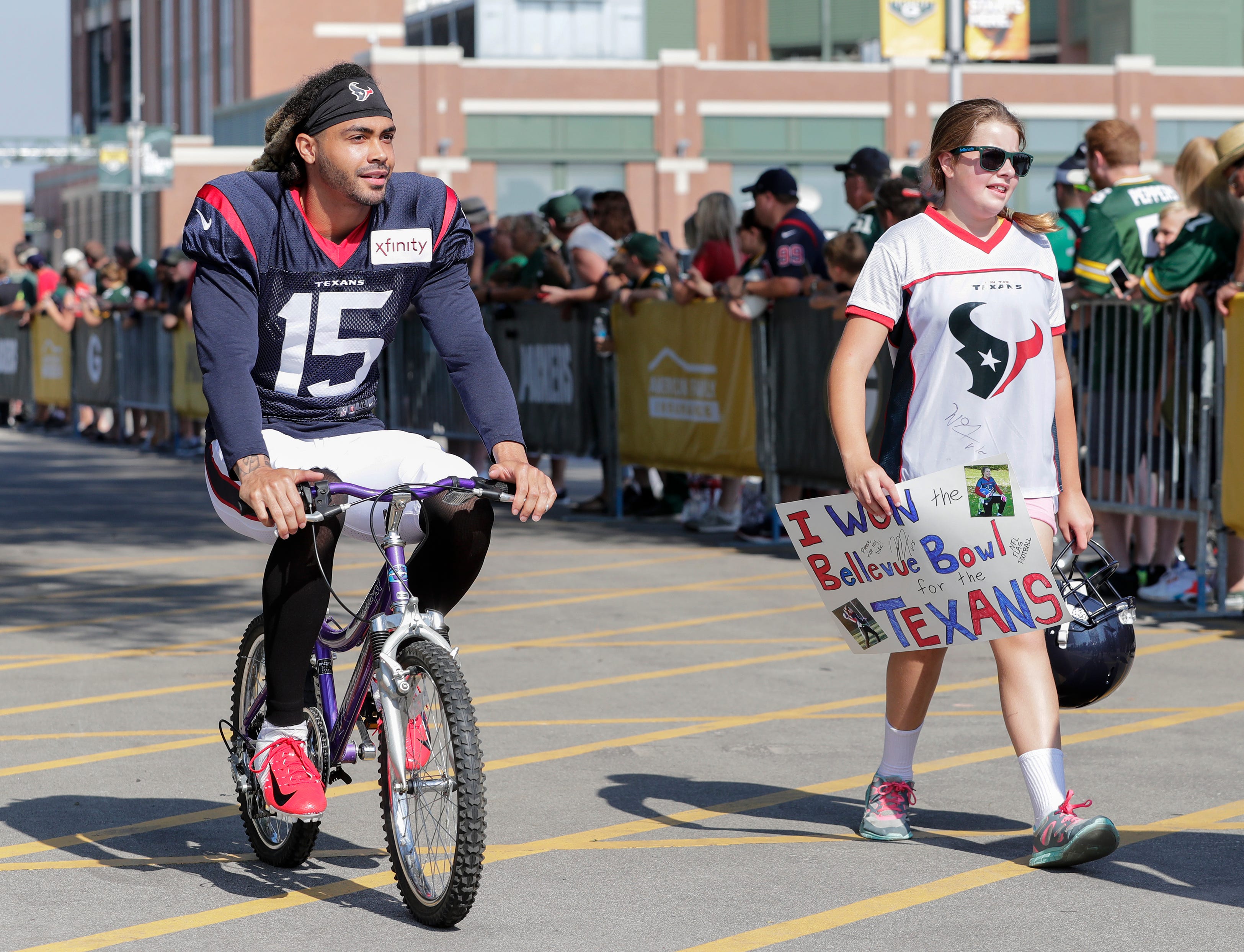 Texans wide receiver Will Fuller V (15) rides a bike to Clarke Hinkle Field for a joint training camp practice with the Green Bay Packers Monday, August 5, 2019, in Ashwaubenon, Wis.
