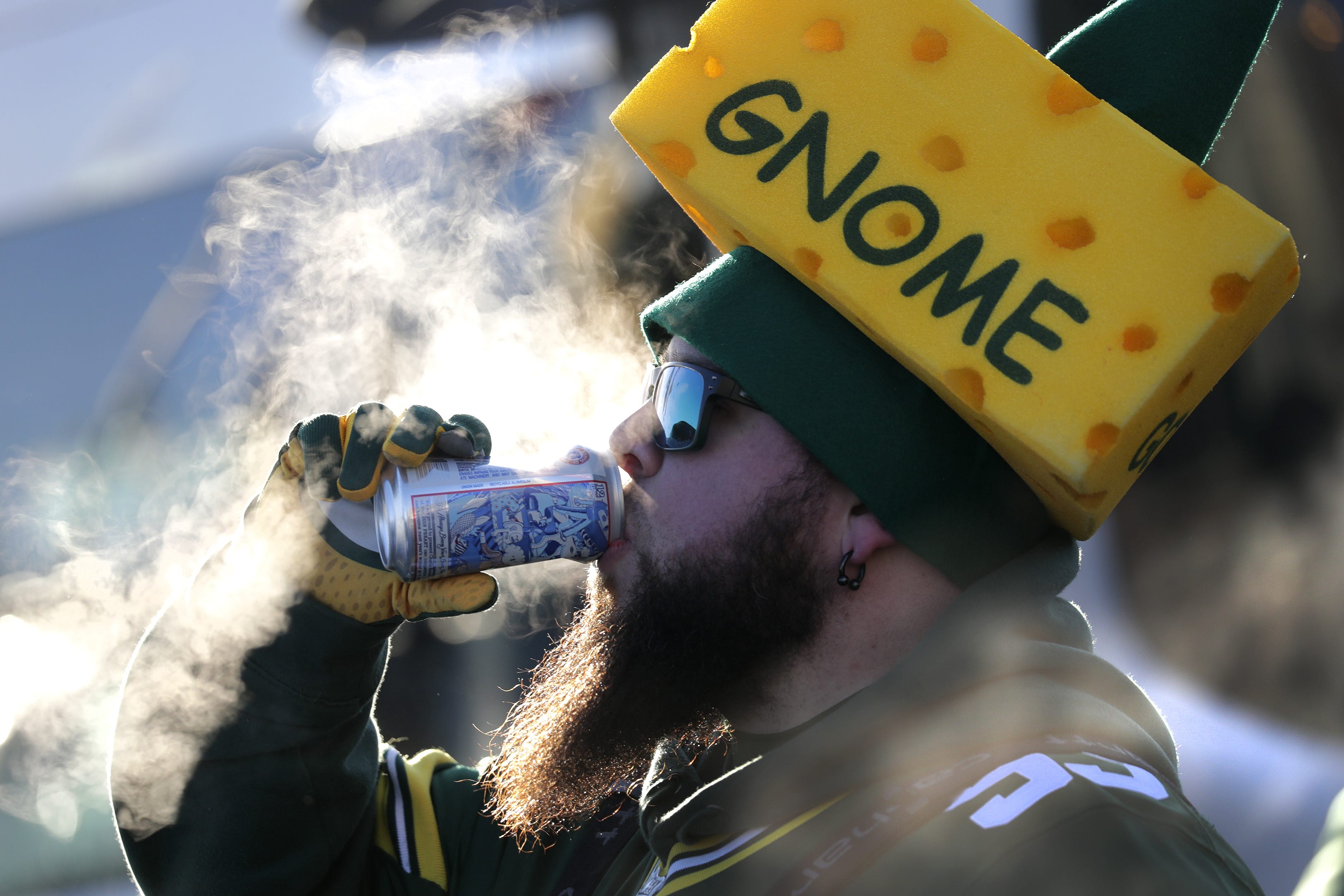 Chris St. Amour of Green Bay braves the cold to enjoy a beverage while tailgating before the Green Bay Packers play against the Chicago Bears Sunday, December 15, 2019, at Lambeau Field in Green Bay, Wis.