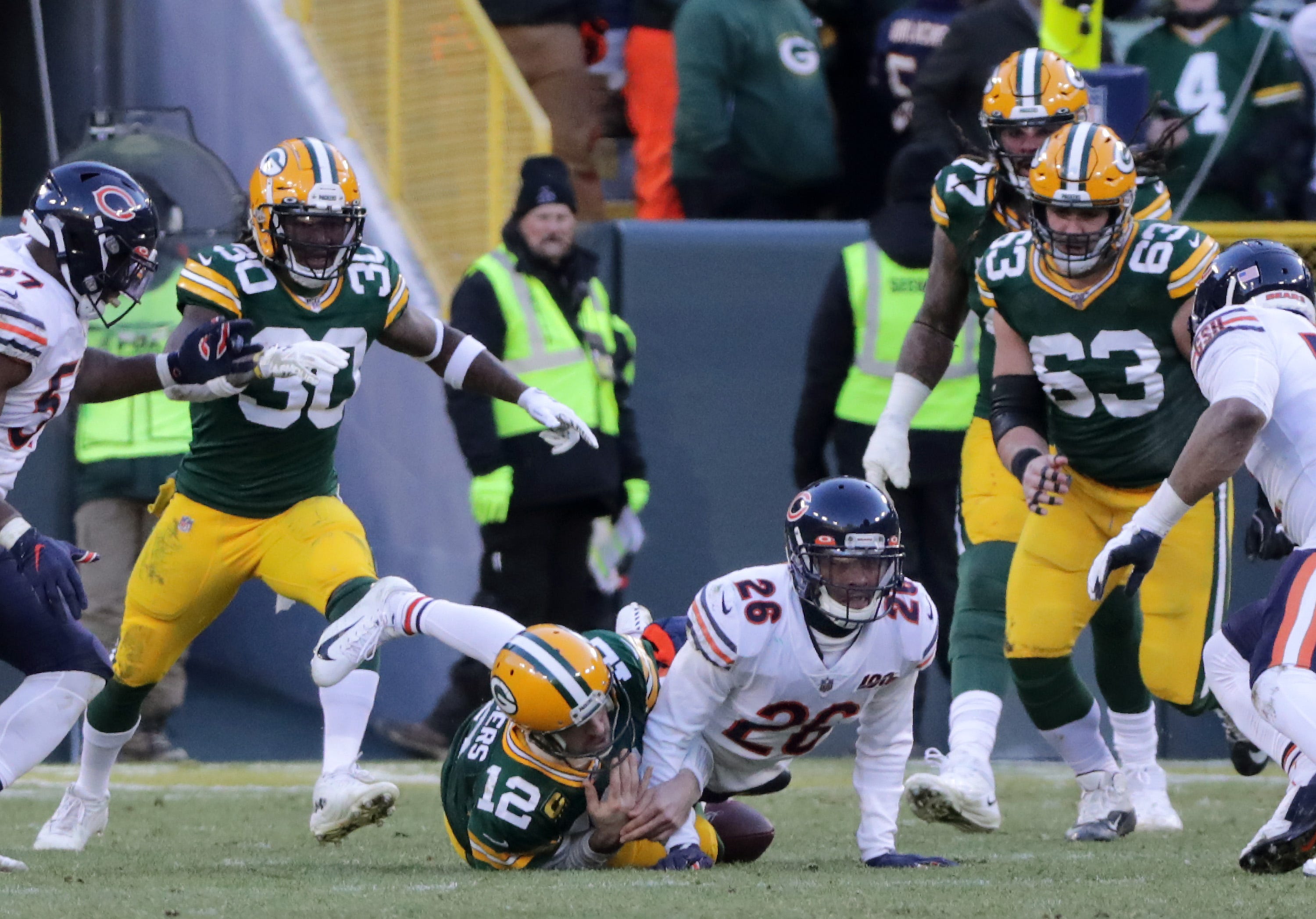 Chicago Bears defensive back Deon Bush (26) knoicks the ball losse while tackl;ing Green Bay Packers quarterback Aaron Rodgers (12) late in the fourth quarter during their football game on Sunday, December 15, 2019, at Lambeau Field in Green Bay, Wis. Rodgers was ruled down.