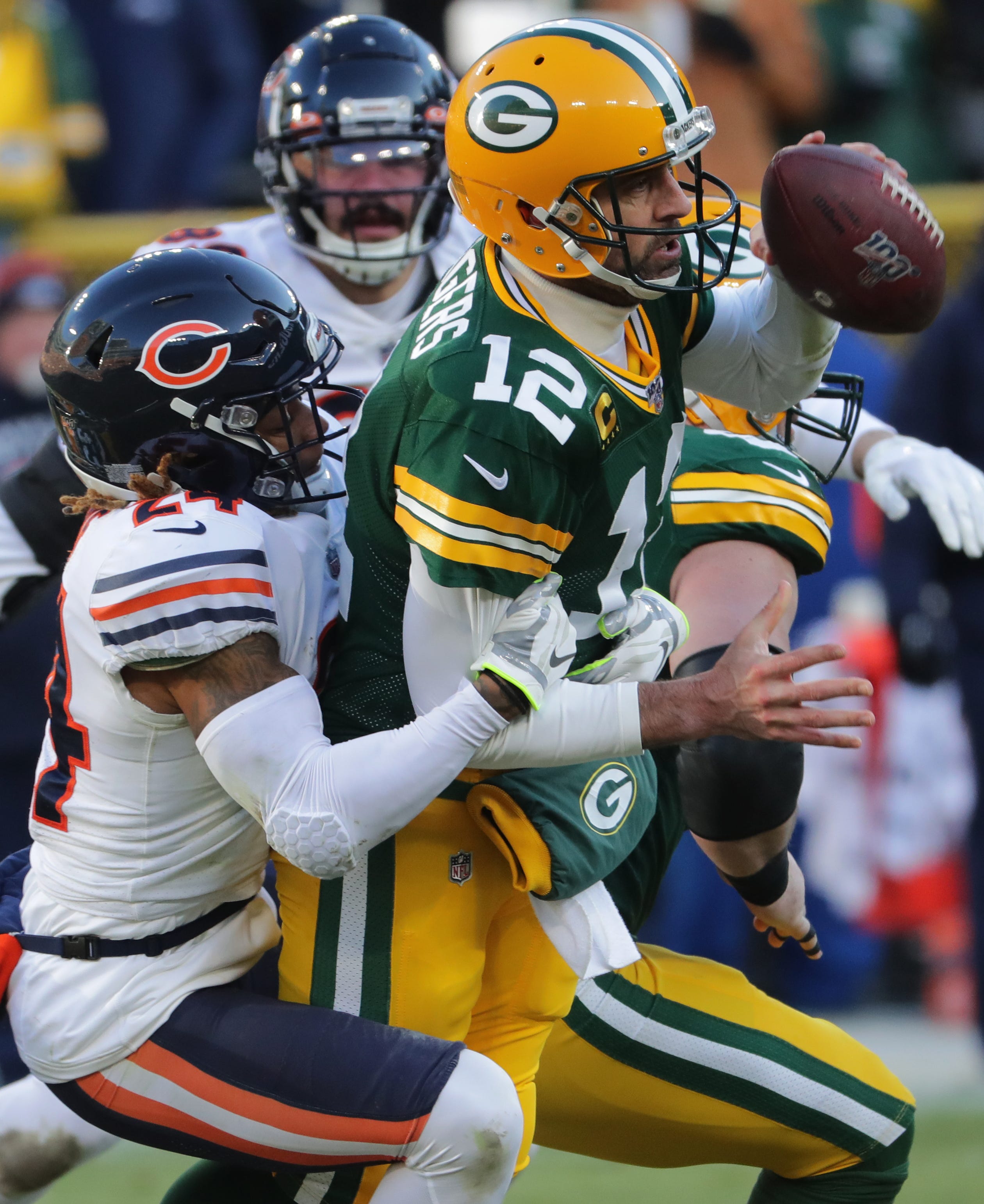 Green Bay Packers quarterback Aaron Rodgers (12) manages to avoid a sack bystander Chicago Bears cornerback Buster Skrine (24) during the fourth quarter of their game Sunday, December 15, 2019 at Lambeau Field in Green Bay, Wis. The Green Bay Packers beat the Chicago Bears 21-13.
