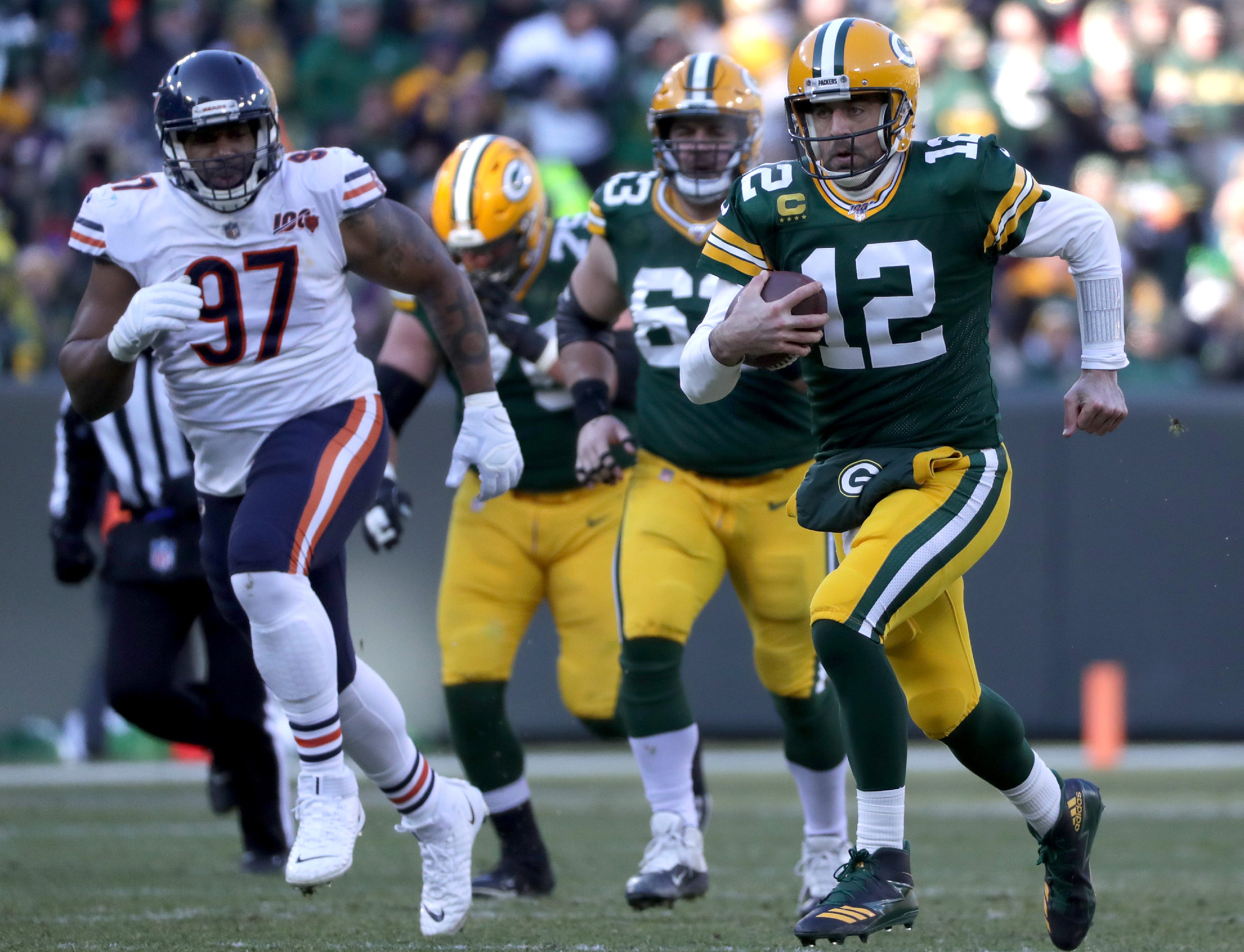 Green Bay Packers quarterback Aaron Rodgers (12) scrammbles on the first drive of the third quarter against the Chicago Bears during their football game on Sunday, December 15, 2019, at Lambeau Field in Green Bay, Wis.