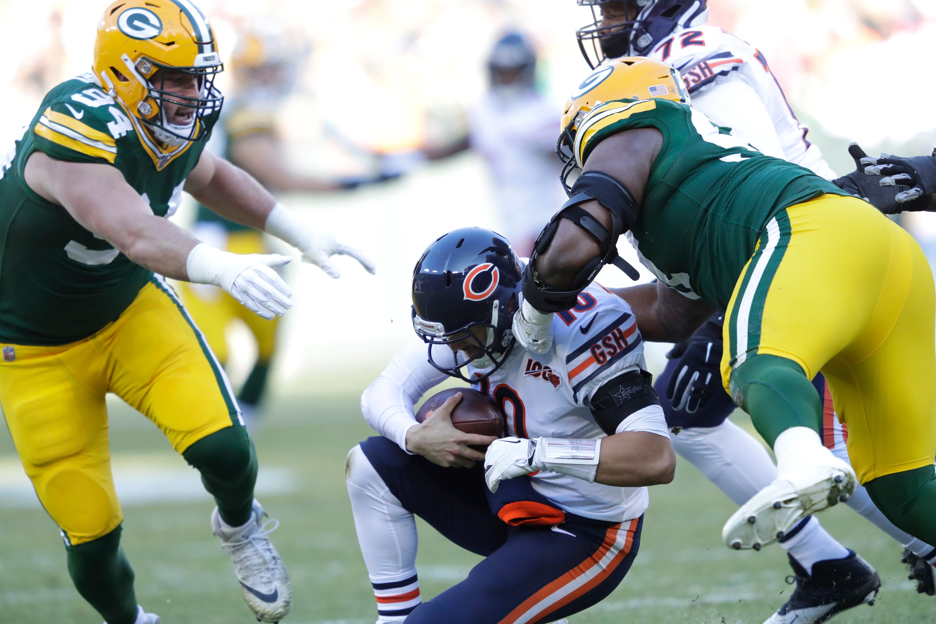 Chicago Bears quarterback Mitchell Trubisky (10) is sacked by Green Bay Packers nose tackle Kenny Clark (97) as Dean Lowry (94) moves in on the play Sunday, December 15, 2019, at Lambeau Field in Green Bay, Wis.