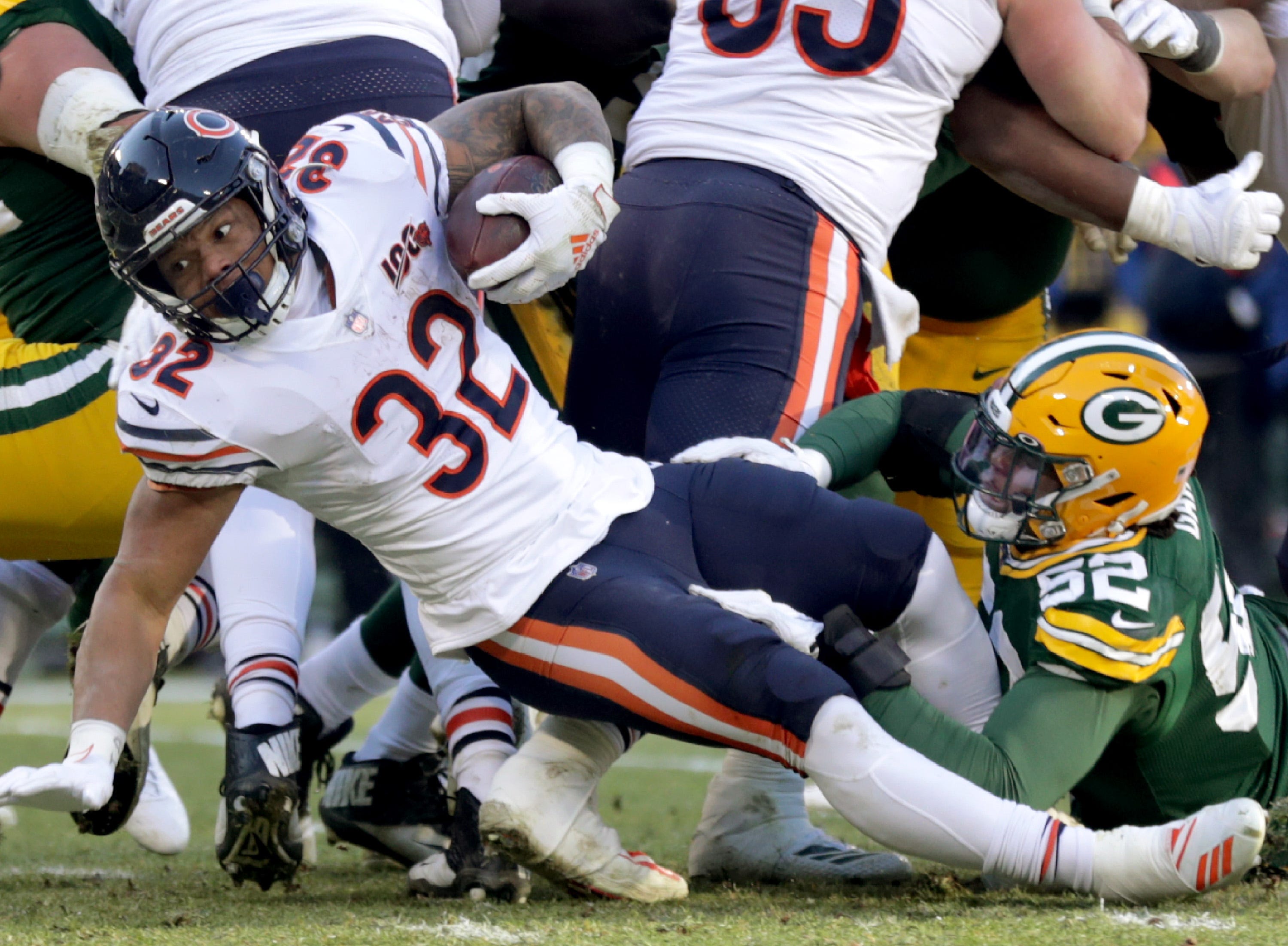 Chicago Bears running back David Montgomery (32) stretches for yards while being tackled by Green Bay Packers linebacker Rashan Gary (52) during their football game on Sunday, December 15, 2019, at Lambeau Field in Green Bay, Wis.