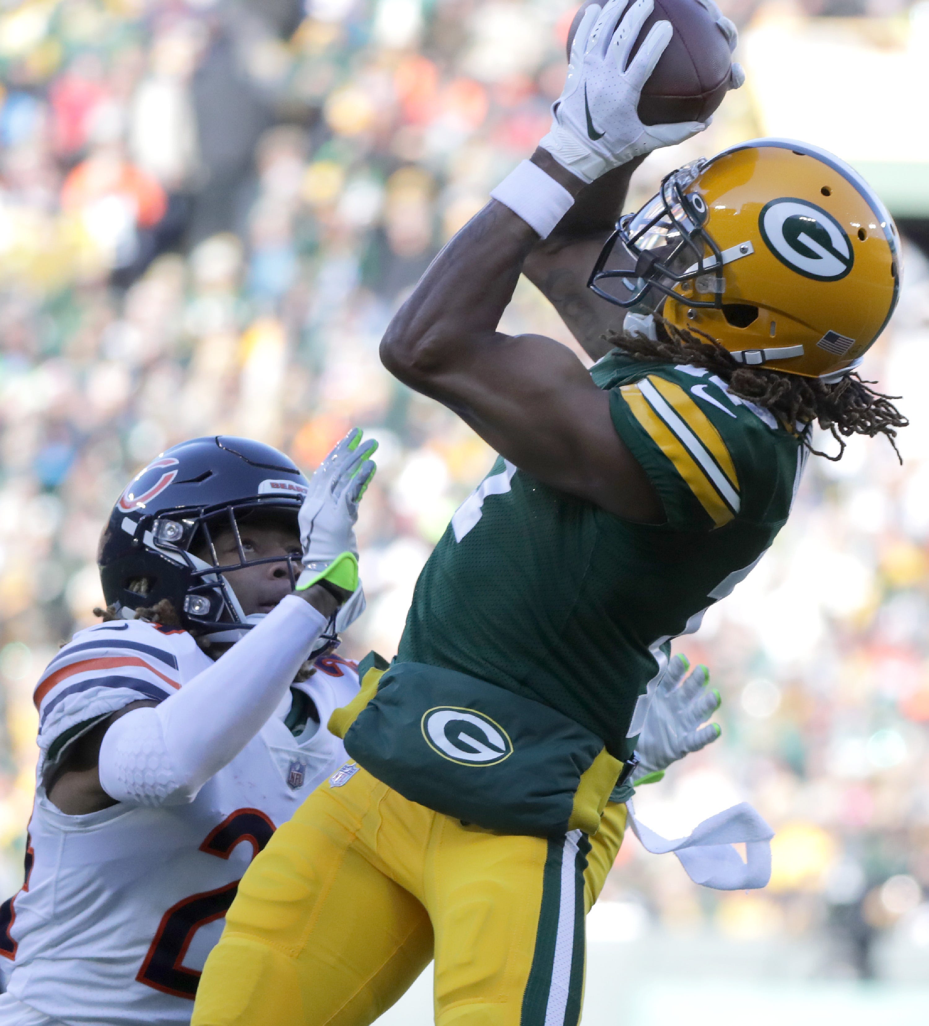 Green Bay Packers wide receiver Davante Adams (17) catches a first quarter touchdown pass over the defense of Chicago Bears cornerback Buster Skrine (24) during their football game on Sunday, December 15, 2019, at Lambeau Field in Green Bay, Wis.