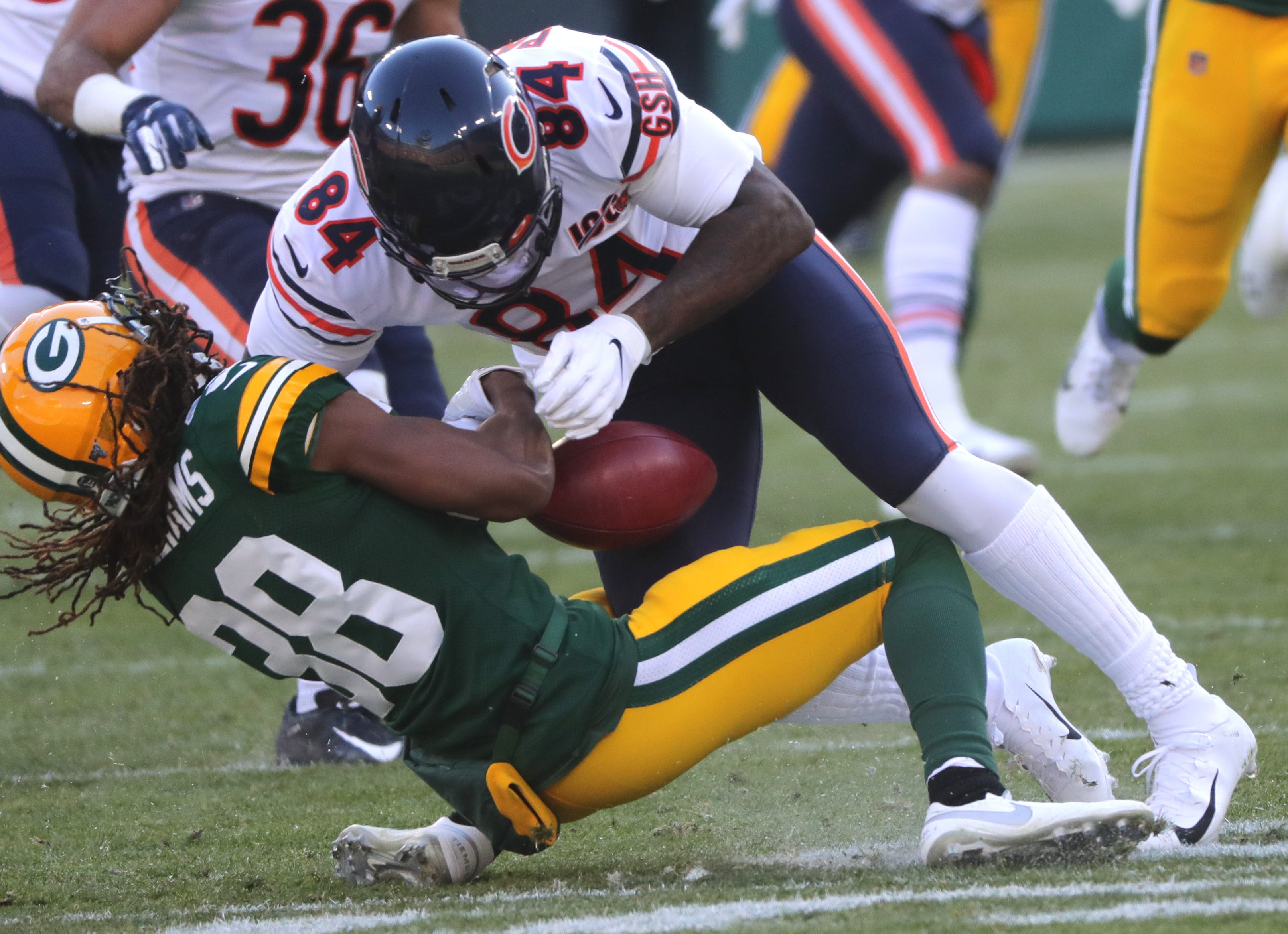 Chicago Bears wide receiver Cordarrelle Patterson (84) drills Green Bay Packers cornerback Tramon Williams (38) while field a punt during the first quarter of their game Sunday, December 15, 2019 at Lambeau Field in Green Bay, Wis. The Bears were penalized for interference on the play.