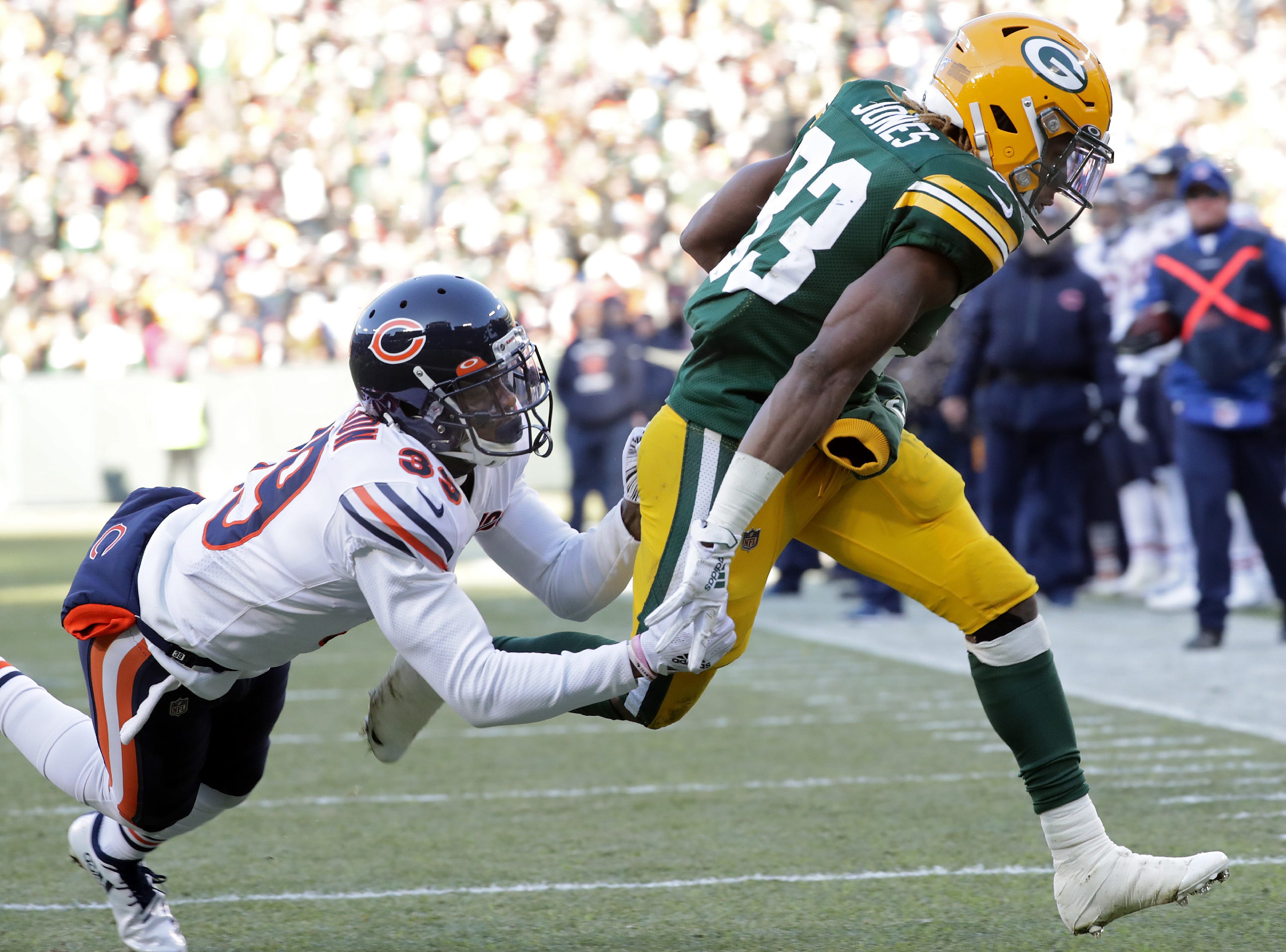 Green Bay Packers running back Aaron Jones (33) rushes for a third quarter touchdown against the defense of the Chicago Bears free safety Eddie Jackson (39) during their football game on Sunday, December 15, 2019, at Lambeau Field in Green Bay, Wis.
