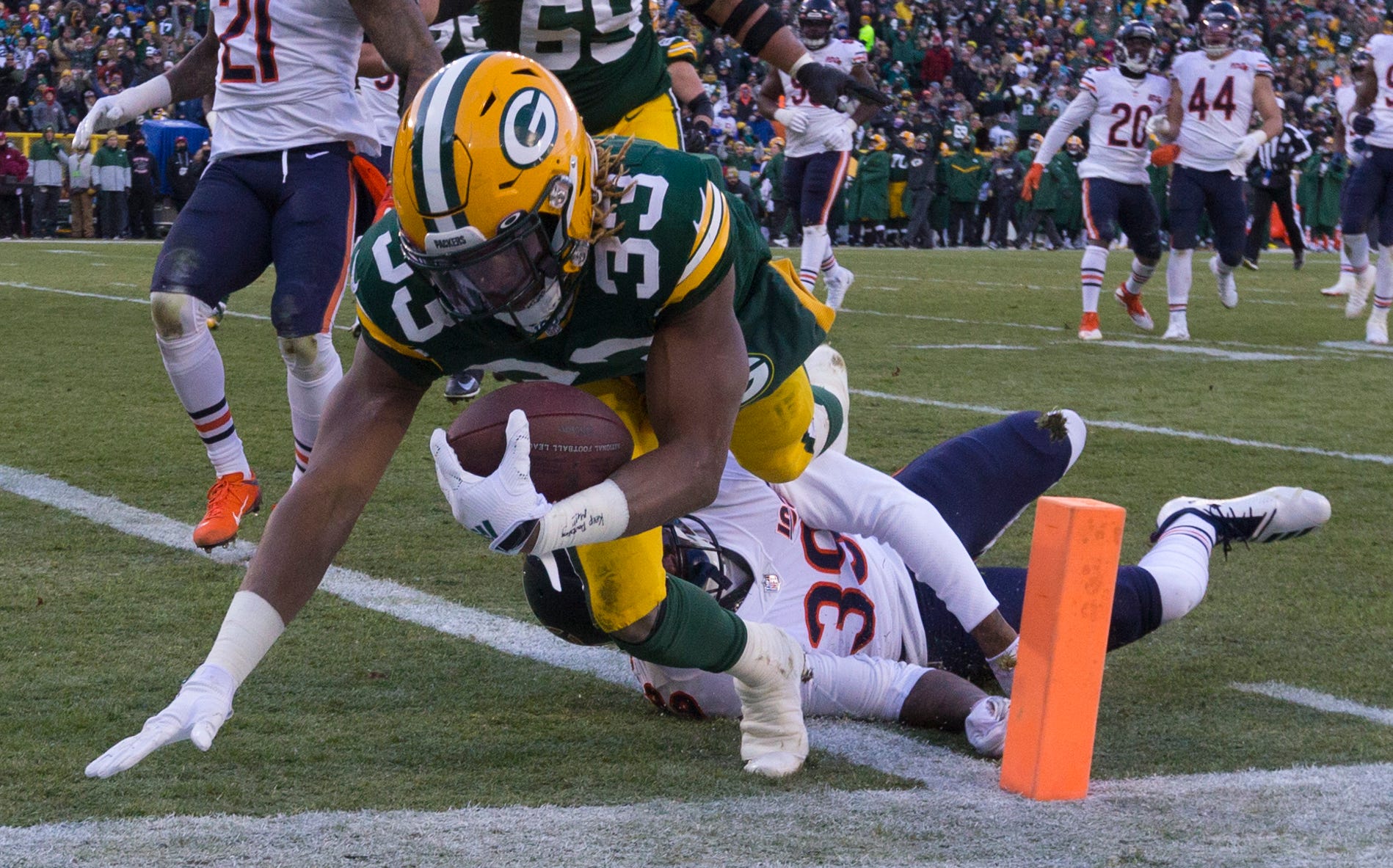 Green Bay Packers running back Aaron Jones (33) scores touchdown on a 21-yard run despite the efforts of Chicago Bears free safety Eddie Jackson (39) during the third quarter of their game Sunday, December 15, 2019 at Lambeau Field in Green Bay, Wis. The Green Bay Packers beat the Chicago Bears 21-13.