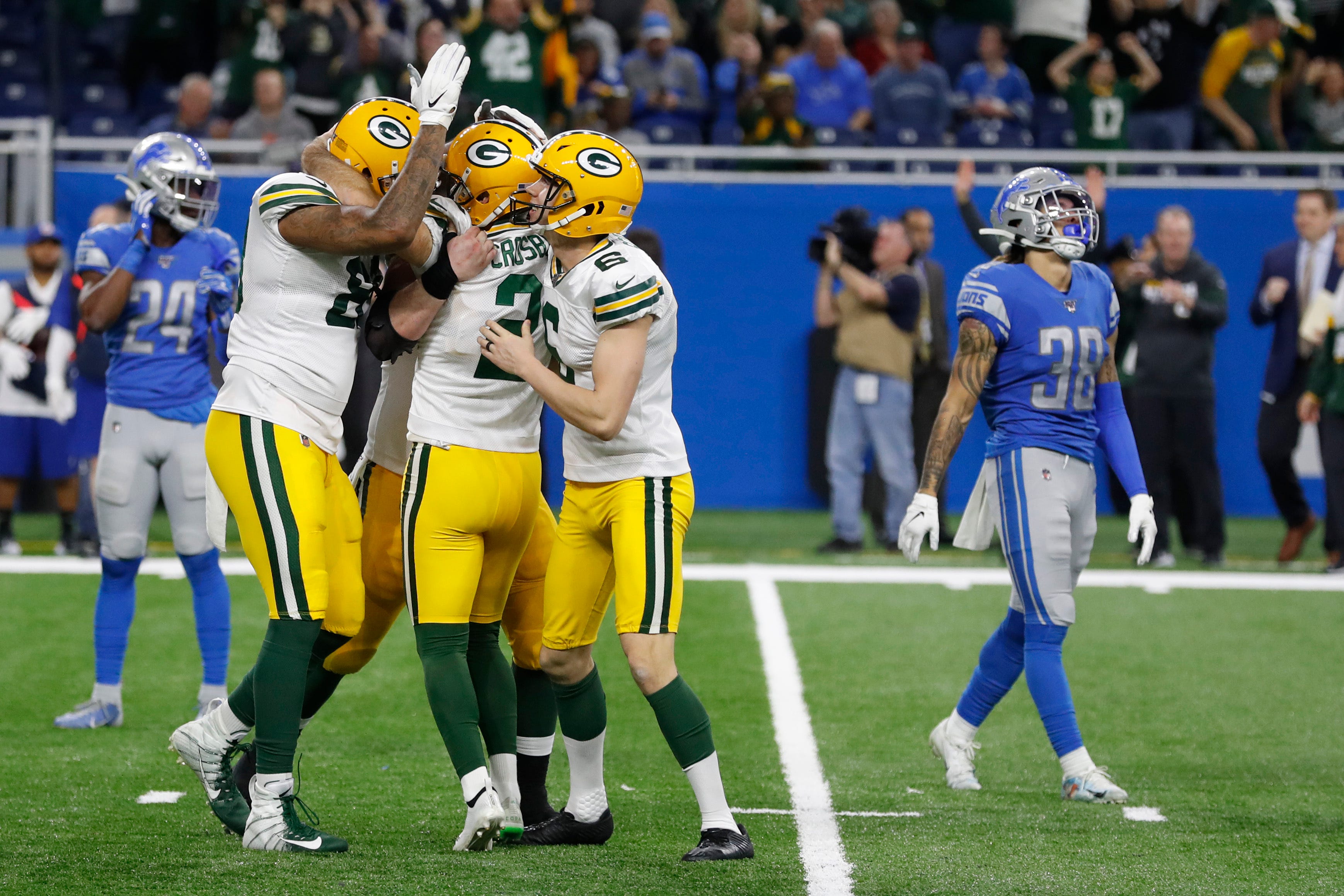 Green Bay Packers surround kicker Mason Crosby (2) after his winning field goal during the second half of an NFL football game against the Detroit Lions, Sunday, Dec. 29, 2019, in Detroit. (AP Photo/Carlos Osorio)
