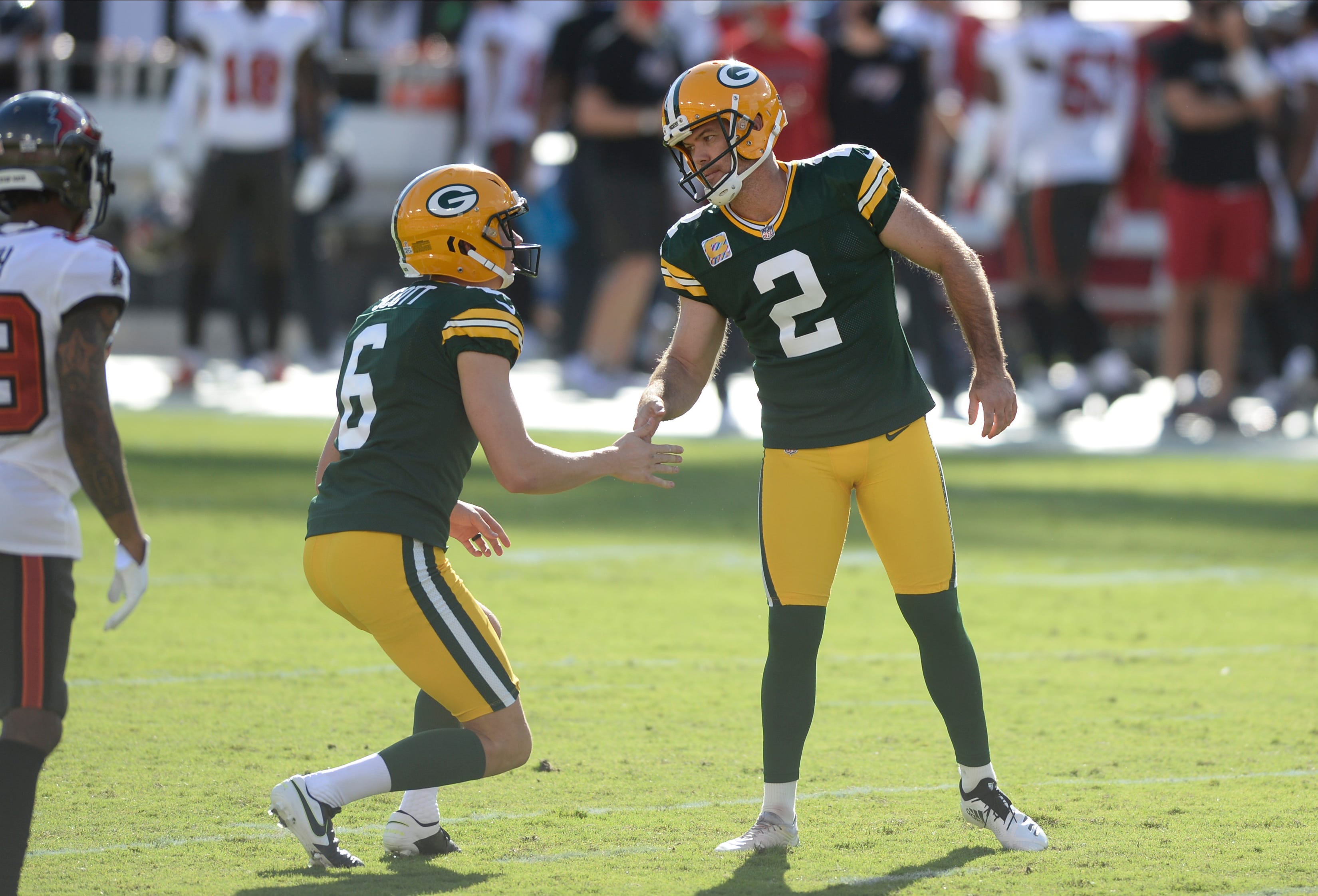 Green Bay Packers' Mason Crosby (2) celebrates with J.K. Scott (6) after kicking a field goal against the Tampa Bay Buccaneers during the first half of an NFL football game Sunday, Oct. 18, 2020, in Tampa, Fla.