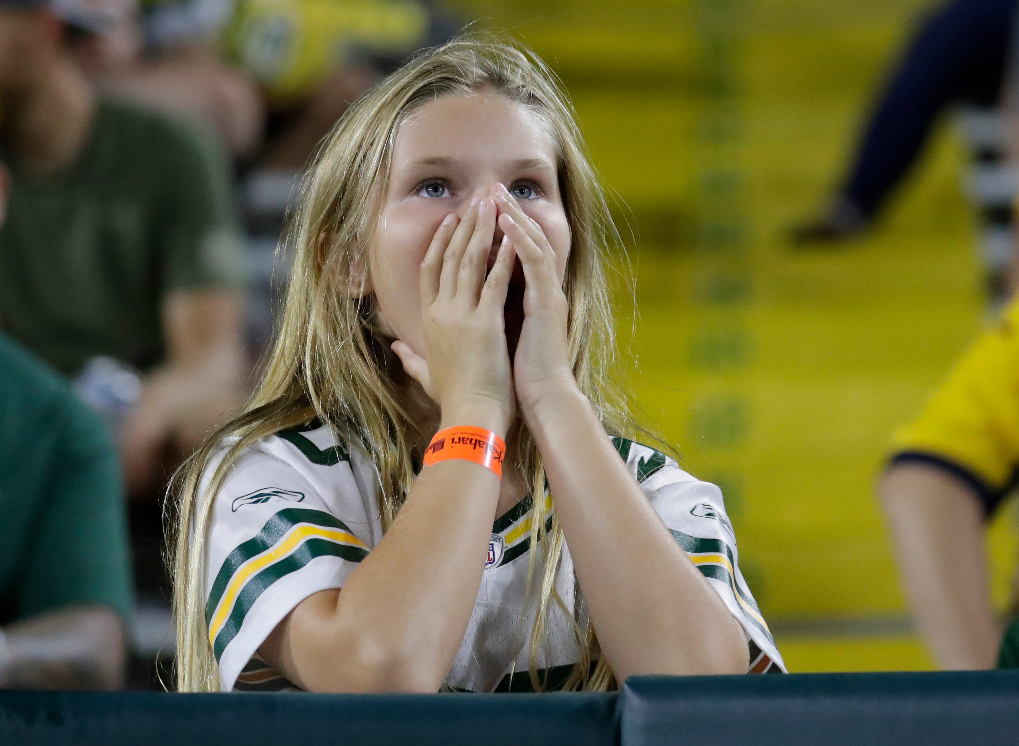 Green Bay Packers fan Stella Wein, 11, of Menomonee Falls looks on as the team falls farther behind the Houston Texans in the fourth quarter during their football game at Lambeau Field in Green Bay.