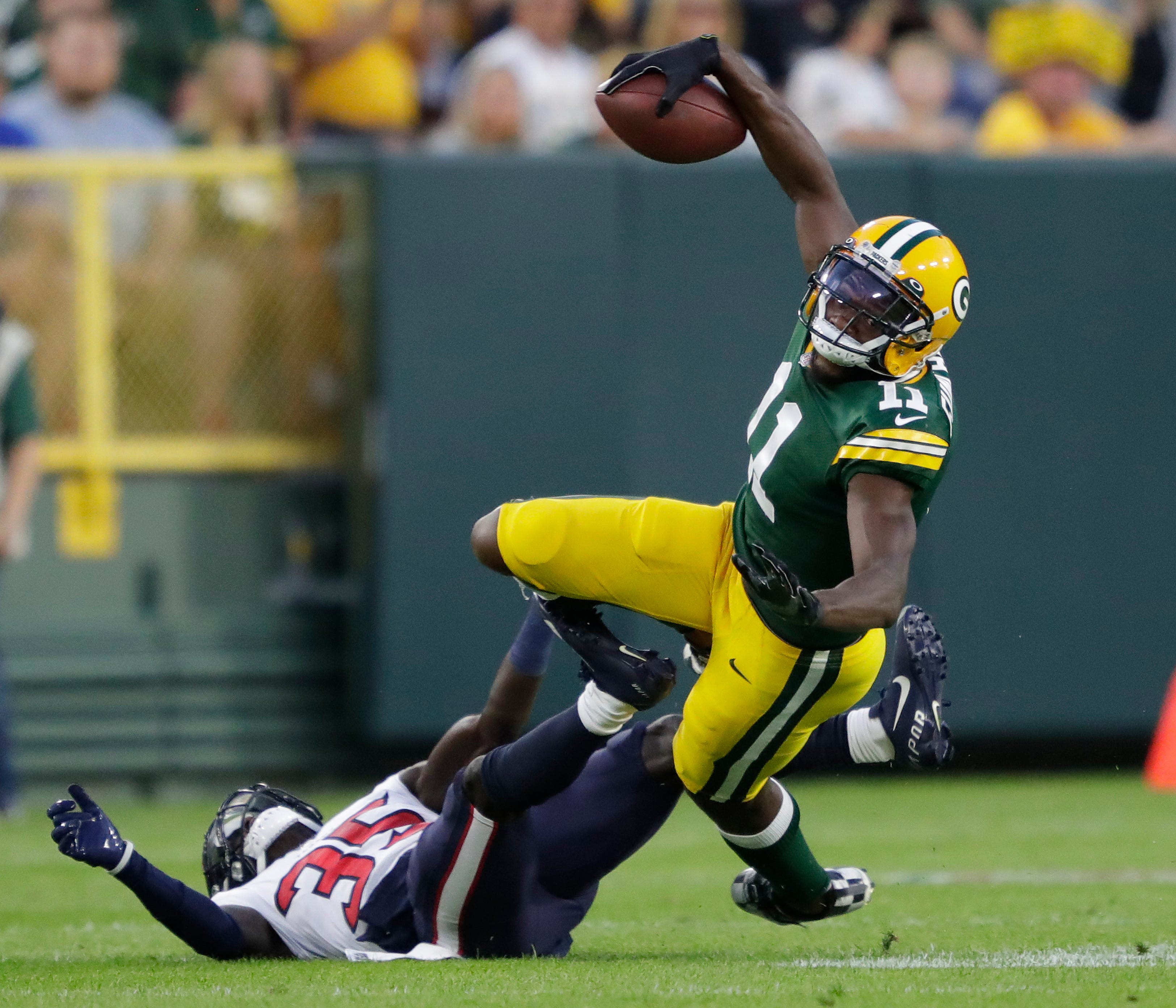 Green Bay Packers wide receiver Devin Funchess (11) pulls down a reception against Houston Texans cornerback Keion Crossen (35) during a preseason game on Saturday, Aug. 14, 2021, at Lambeau Field in Green Bay.