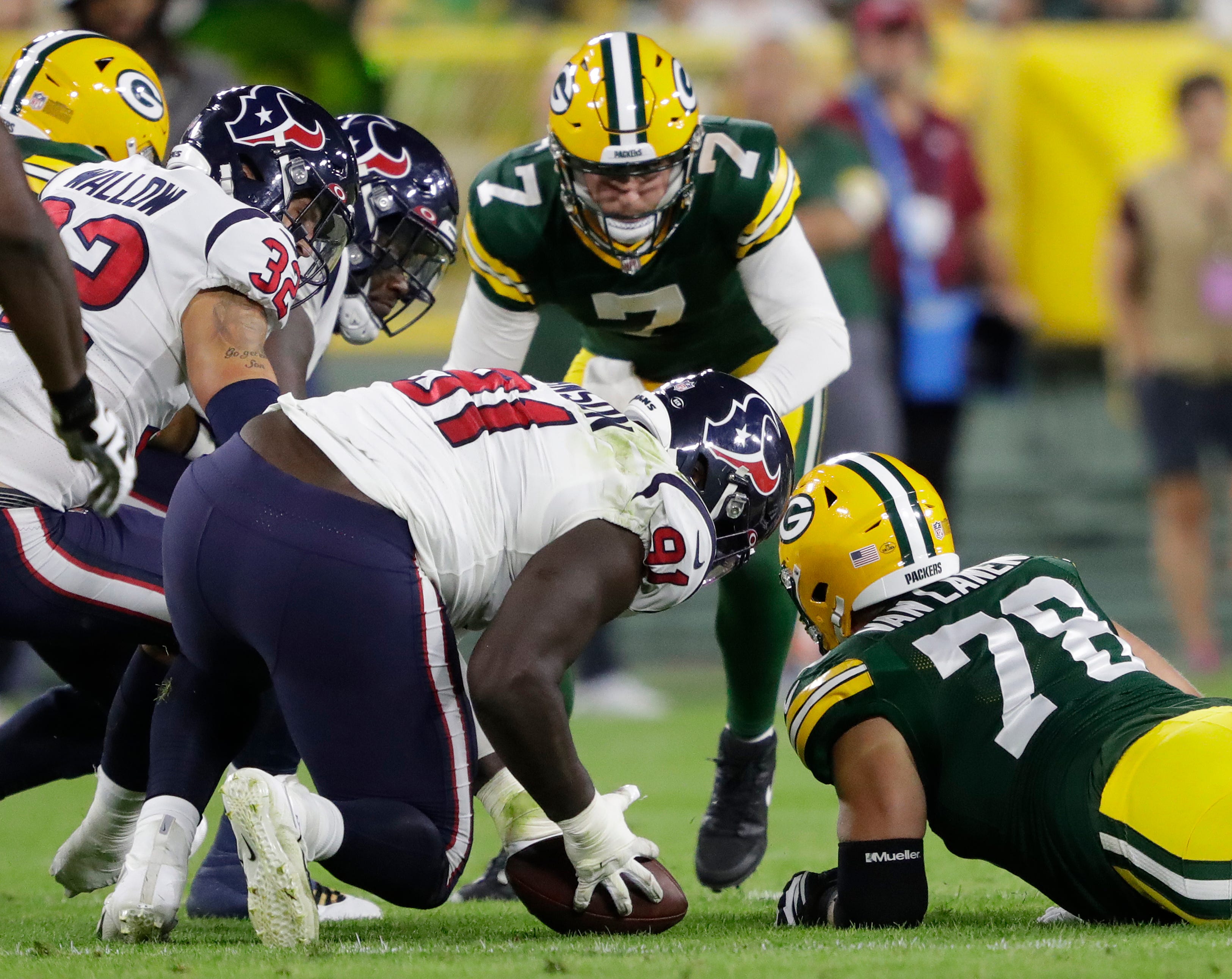 Houston Texans defensive tackle Jaleel Johnson (91) recovers a fumble against Green Bay Packers quarterback Kurt Benkert (7) and offensive tackle Cole Van Lanen (78) during their football game  at Lambeau Field in Green Bay.