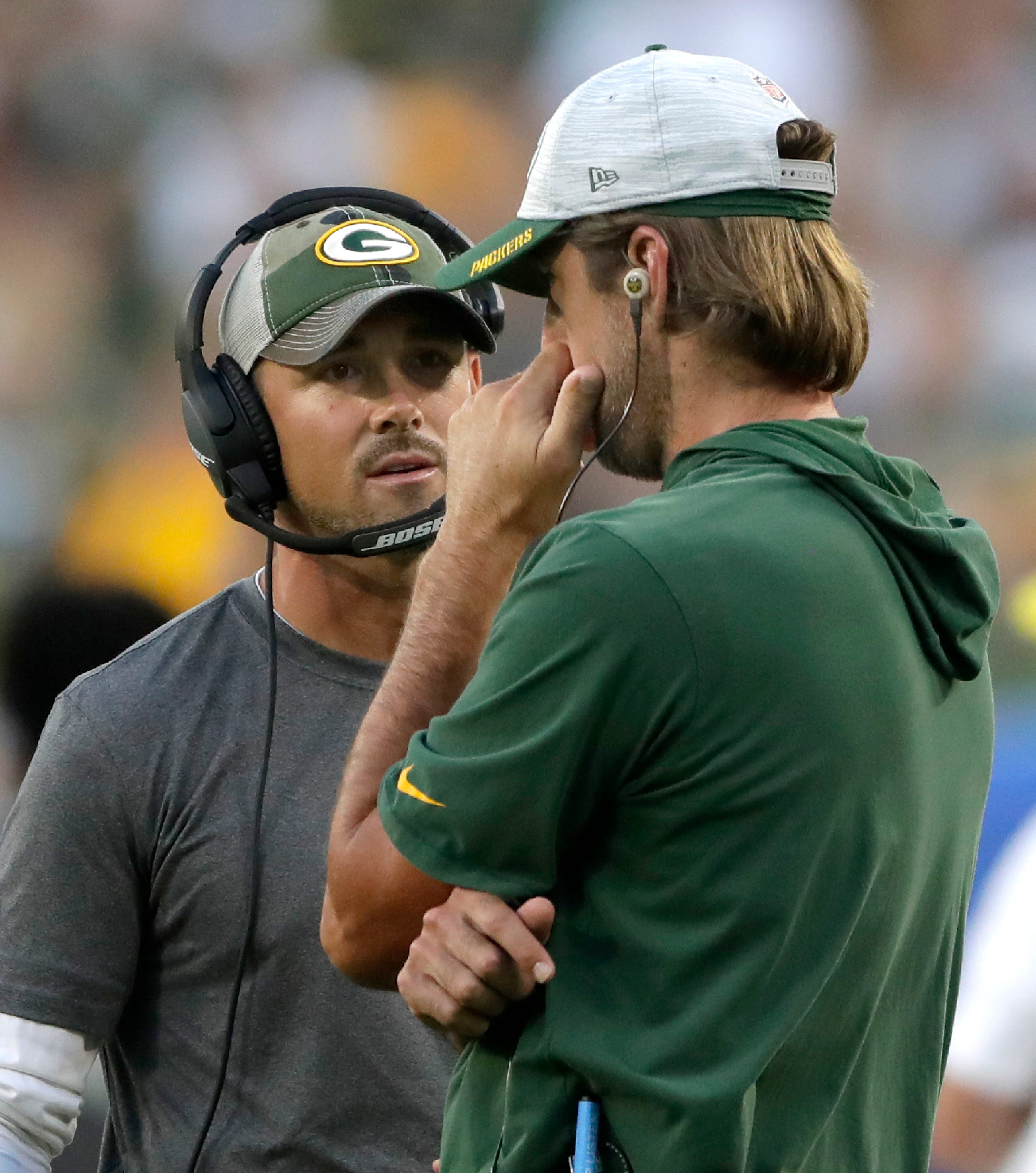 Green Bay Packers quarterback Aaron Rodgers and head coach Matt LaFleur speak on the sidelines during the preseason game against the Houston Texans on Saturday, Aug. 14, 2021, at Lambeau Field in Green Bay.