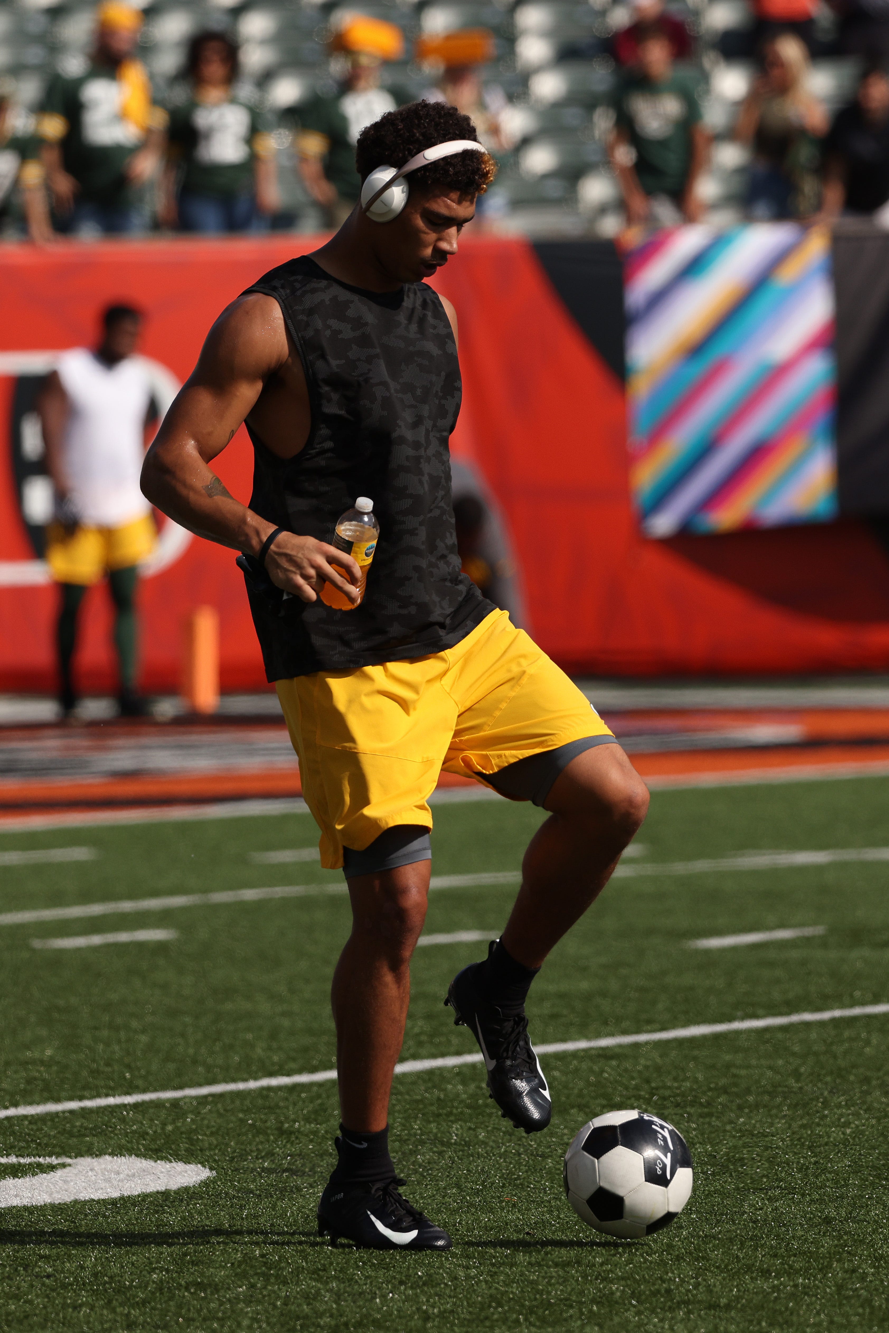 Green Bay Packers wide receiver Allen Lazard kicks a soccer ball on the field before the game against the Cincinnati Bengals on Oct. 10, 2021, at Paul Brown Stadium in Cincinnati.