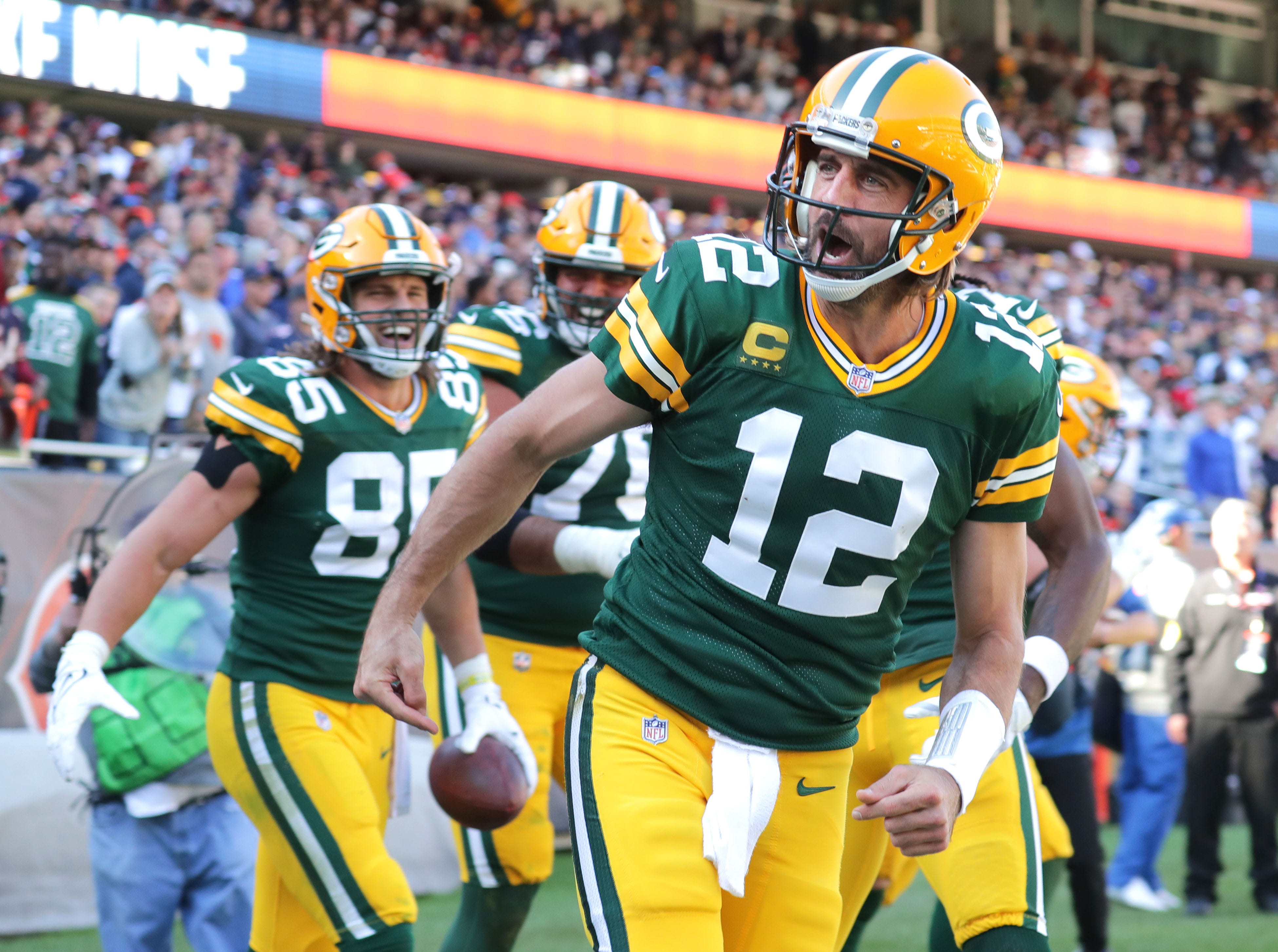 Green Bay Packers quarterback Aaron Rodgers (12) celebrates his rushing touchdown during the fourth quarter of the Green Bay Packers' 24-14 win at Soldier Field in Chicago on Sunday, Oct. 17, 2021. He shouted at fans "I own you, I still own you." Those comments went viral.