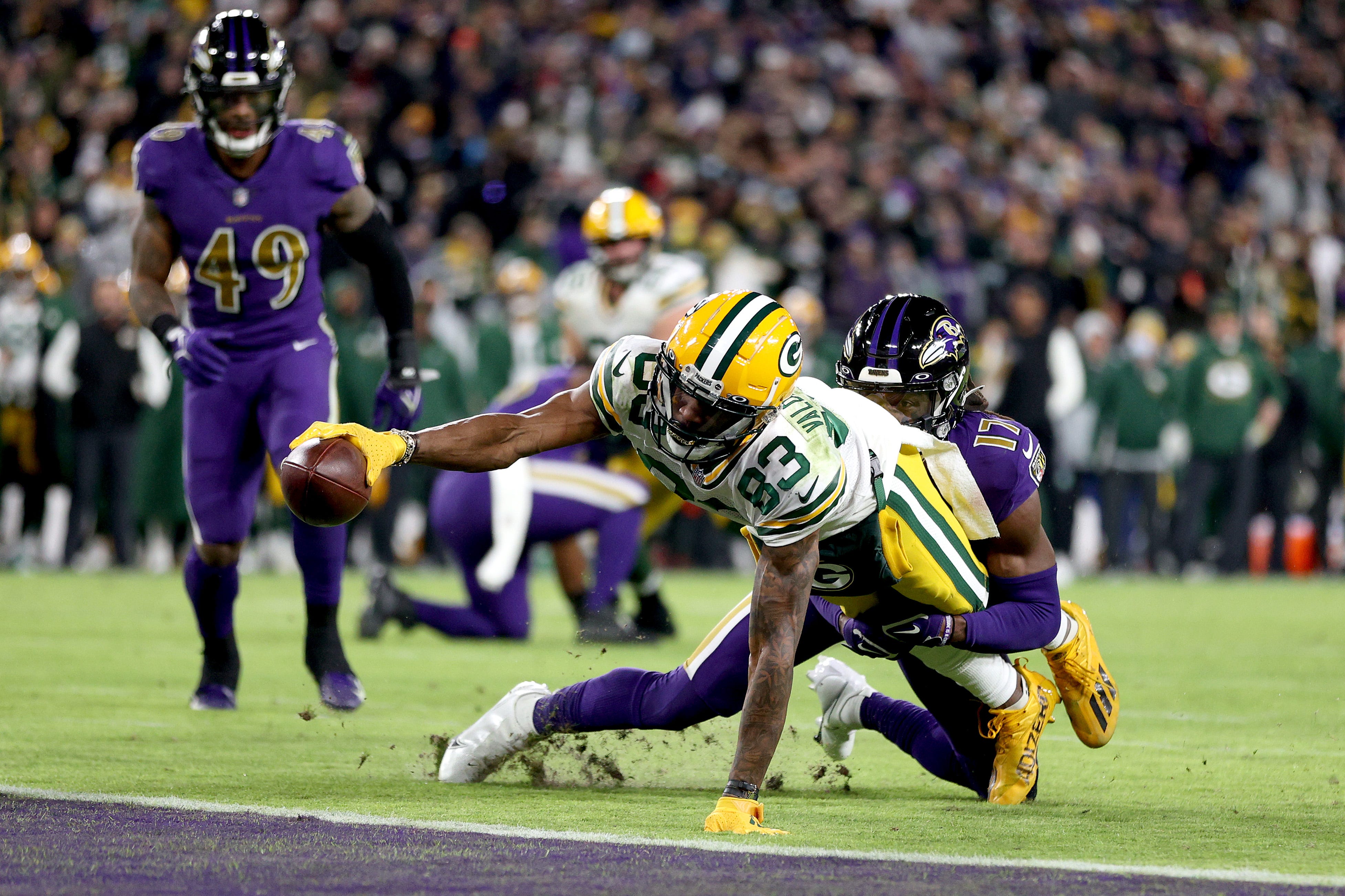 Green Bay Packers wide receiver Marquez Valdes-Scantling reaches toward the goal line to score an 11-yard touchdown with Baltimore Ravens cornerback Robert Jackson holding on in fourth quarter on Sunday, Dec. 19, 2021, at M&T Bank Stadium in Baltimore.