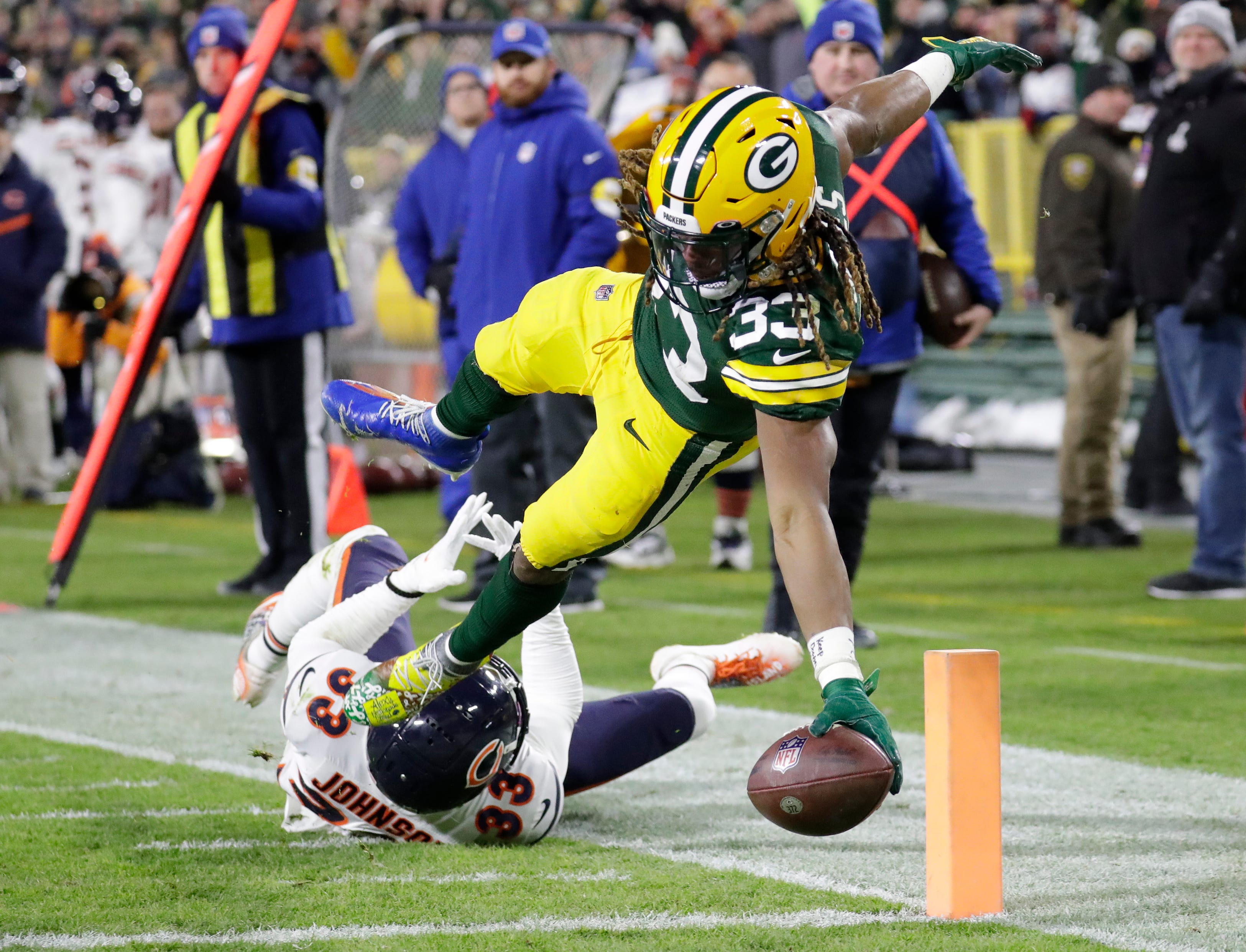 Green Bay Packers running back Aaron Jones (33) dives for a touchdown against Chicago Bears cornerback Jaylon Johnson (33) in the third quarter during their football game Sunday, December 12, 2021, at Lambeau Field in Green Bay, Wis. 
Dan Powers/USA TODAY NETWORK-Wisconsin
