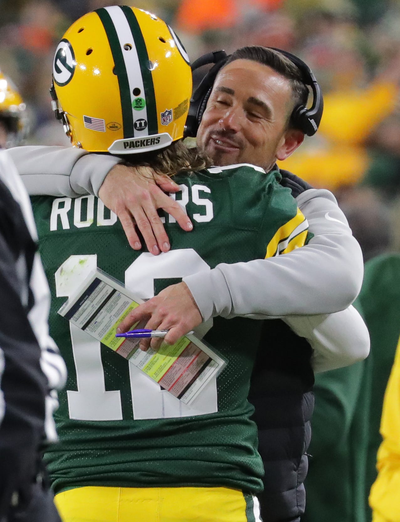 Green Bay Packers head coach Matt LaFleuer hugs quarterback Aaron Rodgers (12) after he threw a touchdown pass during the fourth quarter of their game Sunday, December 12, 2021 at Lambeau Field in Green Bay, Wis. The Green Bay Packers beat the Chicago Bears 45-30.