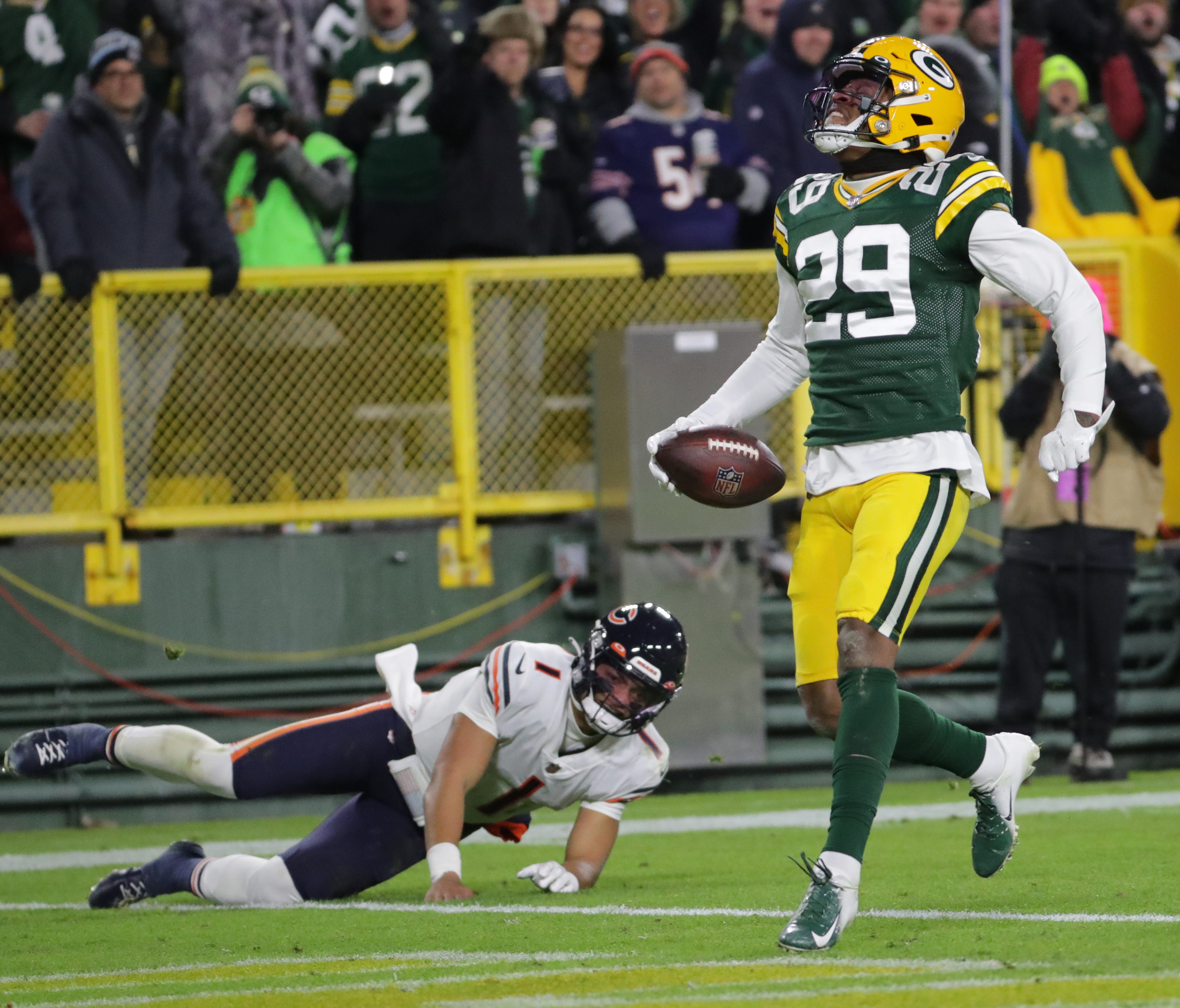 Green Bay Packers cornerback Rasul Douglas (29) celebrates his 55-yard interception return for a touchdown during the second quarter of their game Sunday, December 12, 2021 at Lambeau Field in Green Bay, Wis. In the background is Chicago Bears quarterback Justin Fields (1)