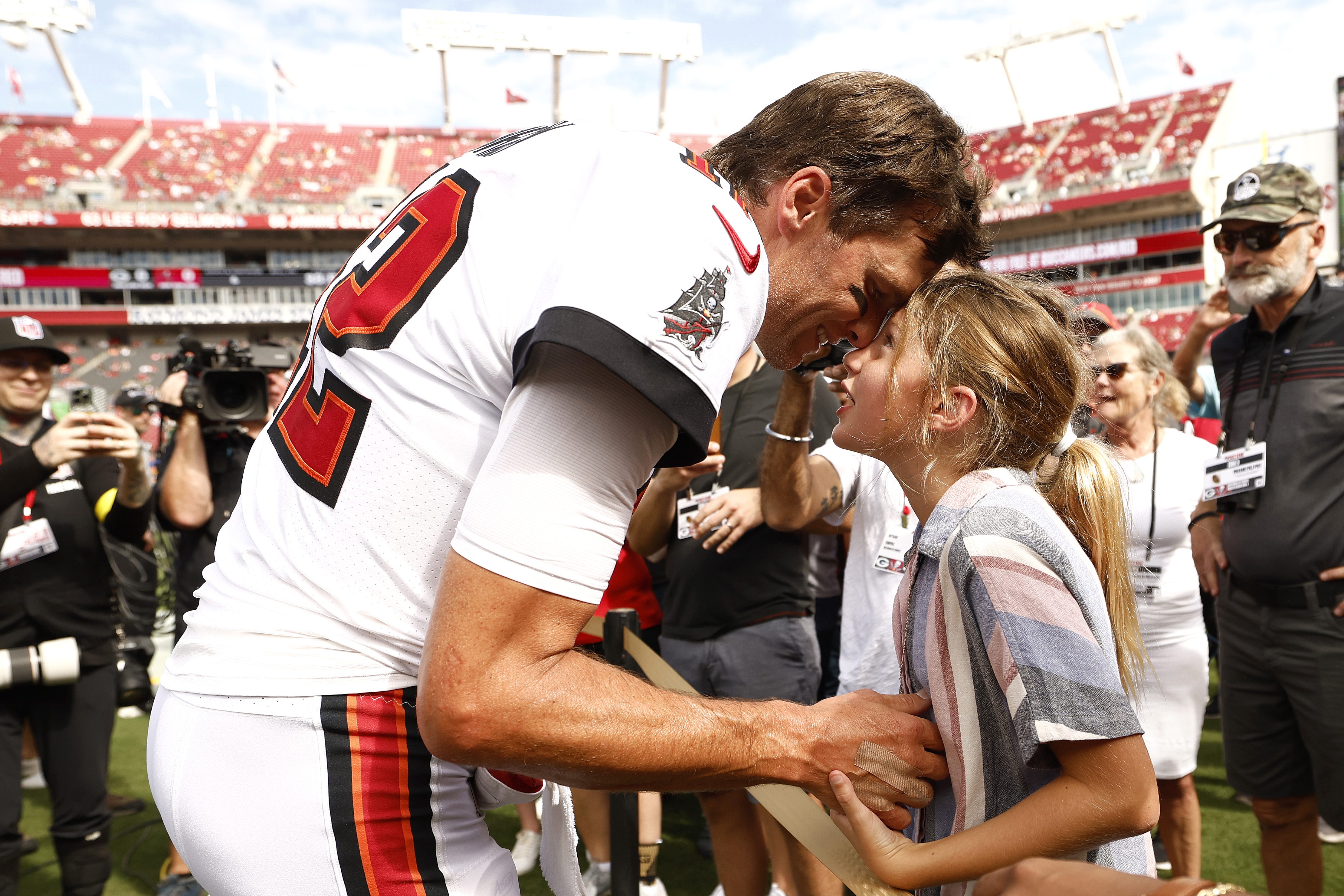 Buccaneers quarterback Tom Brady talks with his daughter, Vivian, on the sidelines prior to the game against the Green Bay Packers on Sept. 25, 2022, at Raymond James Stadium in Tampa, Florida.