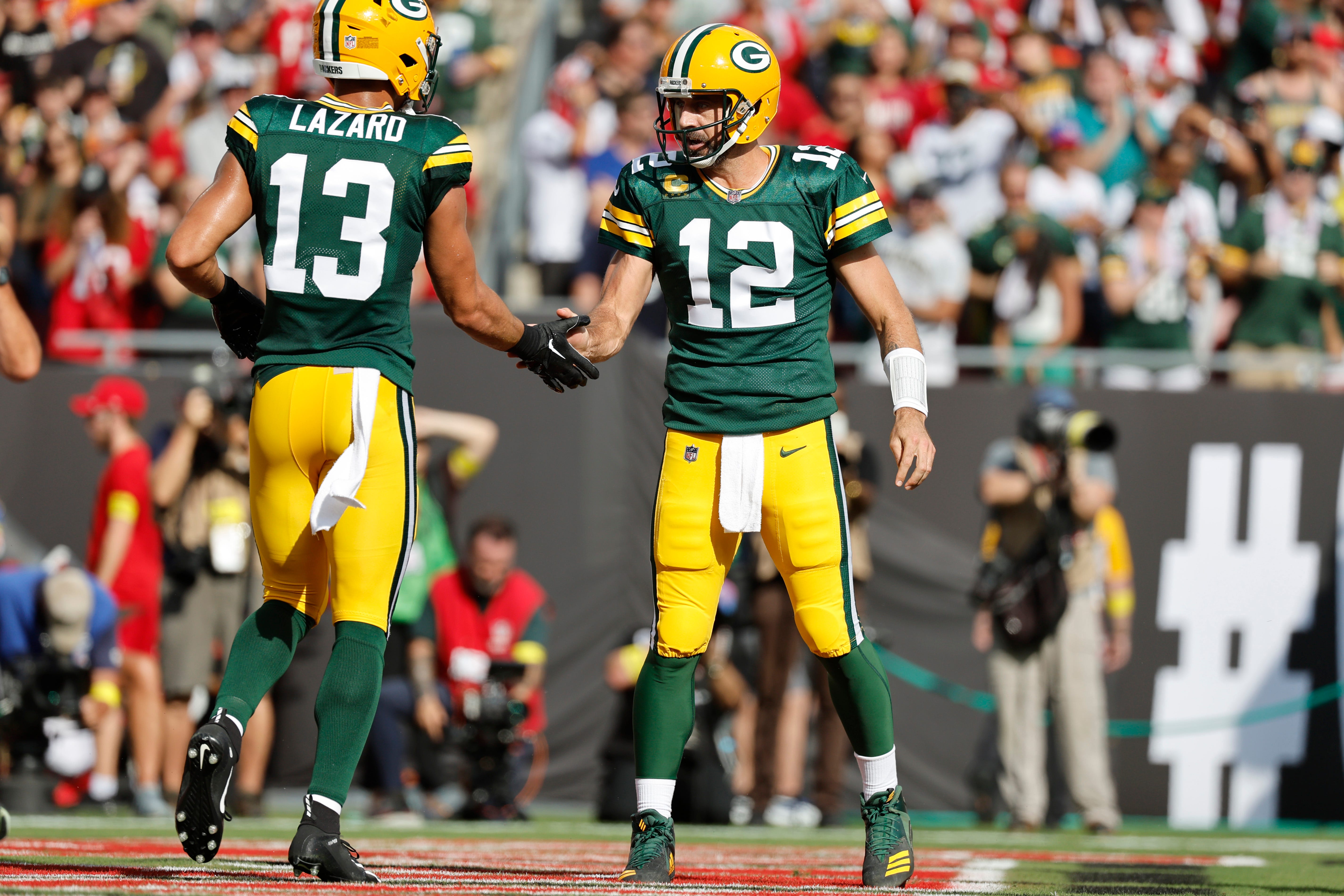 Green Bay Packers quarterback Aaron Rodgers (12) and wide receiver Allen Lazard (13) congratulate each other after a touchdown against the Tampa Bay Buccaneers during the first quarter on Sept. 25, 2022, at Raymond James Stadium in Tampa, Florida.